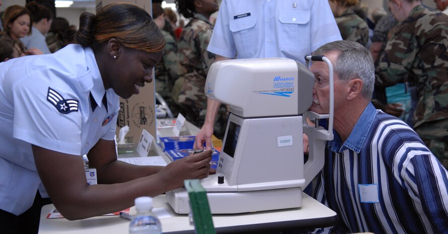 Senior Airman Tosha Parson, 23rd Medical Group, gives Capt. (retired) Don Koski a glaucoma screening during the Retiree Appreciation Day at Moody Air Force Base, Ga. Nov. 3.  Retiree Appreciation Day was the conclusion of a week-long celebration for local military retirees. ( U. S. Air Force Photo by Senior Airman Elizabeth Rissmiiller)