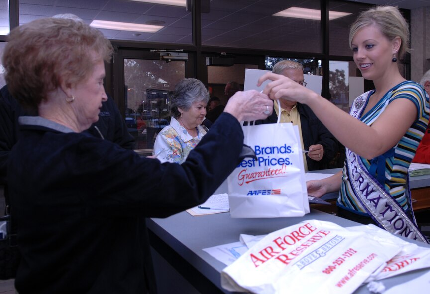 Whitney Kudela, Miss International 2007, hands out goody bags to former servicemembers and dependents during the Retiree Appreciation Day at Moody Air Force Base, Ga., Nov. 3.  Retiree Appreciation Day was the conclusion of a week-long celebration for retirees. (U.S. Air Force Photo by Senior Airman Elizabeth Rissmiller)