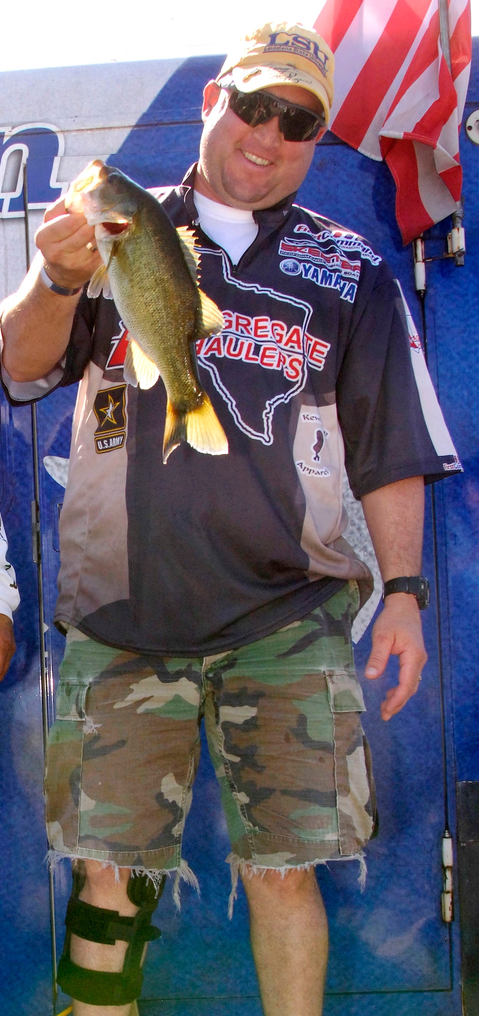 Army Staff Sgt. Deron Santini holds up his catch of the day, Nov. 3, a nearly two-pound largemouth bass, during the Fishing For Freedom event held for injured servicmembers at Choke Canyon Reservoir, Texas. (U.S. Air Force photo/Michael Tolzmann) 
