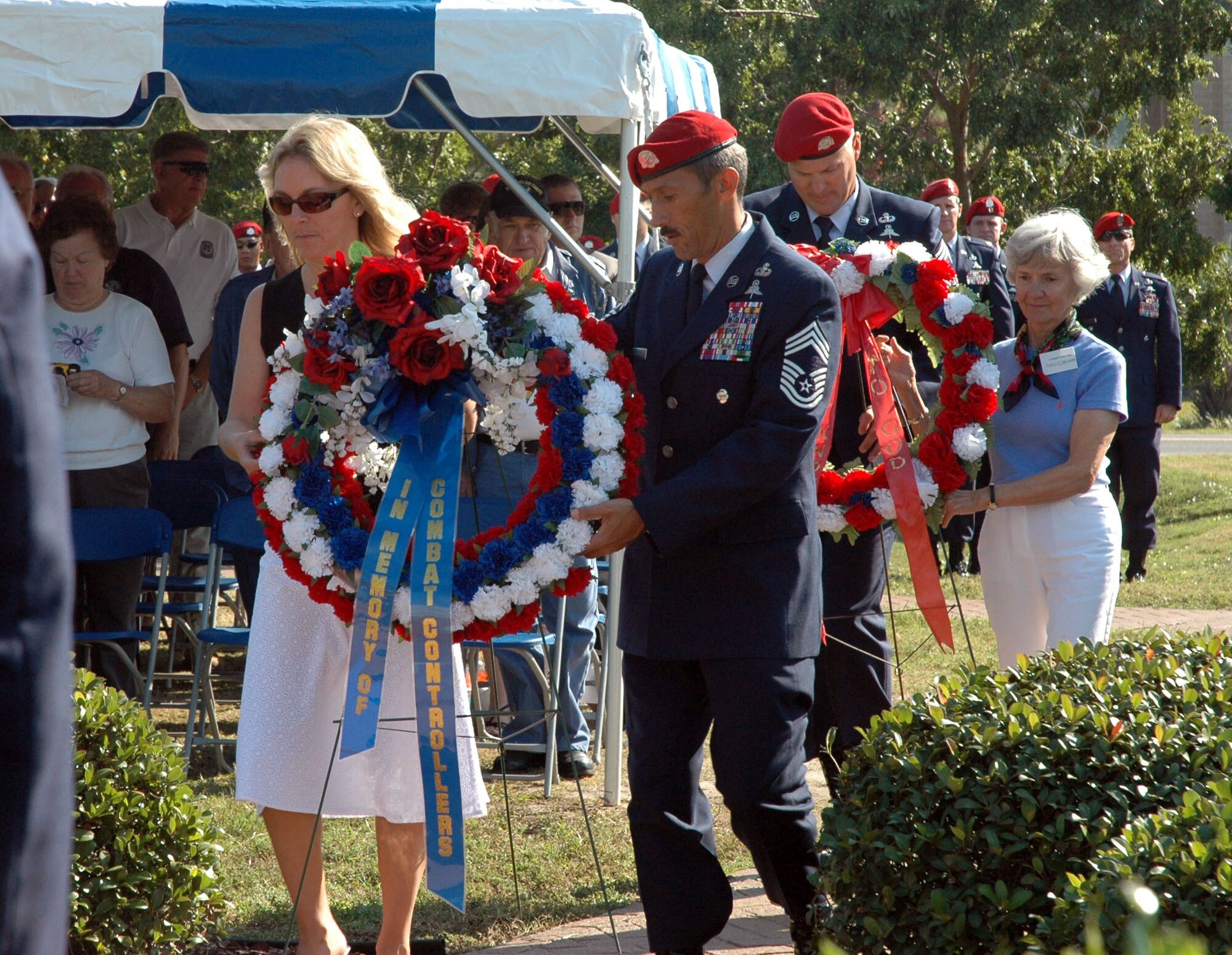 HURLBURT FIELD, Fla. -- Family members of fallen combat controllers lay wreaths during a memorial service held at the combat control memorial here Nov. 3.  Valerie Chapman (left), wife of fallen combat controller and Air Force Cross recipient Tech. Sgt. John Chapman and Doris Maitland, sister of Andre Guillet, listed as missing in action from the Vietnam Conflict, layed wreaths in honor of all the fallen controllers during the Combat Control Association reunion.  Assisting the family members are Chief Master Sgt. Michael Ramos, 720th Special Tactics Group and Chief Master Sgt. Timothy Hoye, 23rd Special Tactics Squadron. (U.S. Air Force photo by Dawn Hart)