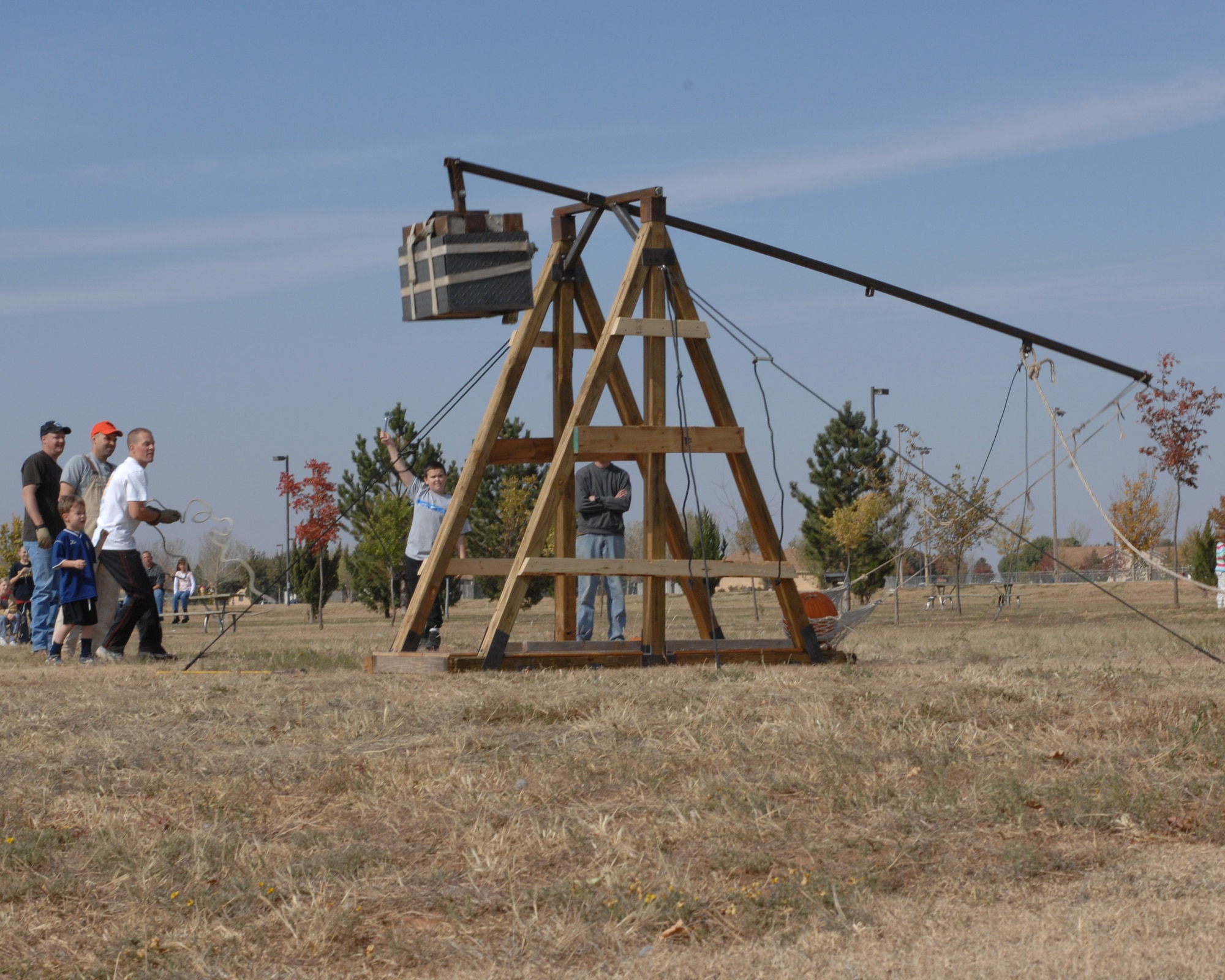 CANNON AIR FORCE BASE, N.M. -- Participants pull the rope on the catapult to watch a pumpkin soar. The Pumpkin Chunkin held Nov. 3 at Doc Stewart Park was a fun way for people to dispose of their leftover Halloween pumpkins. (U.S. Air Force photo by Airman 1st Class Evelyn Chavez)