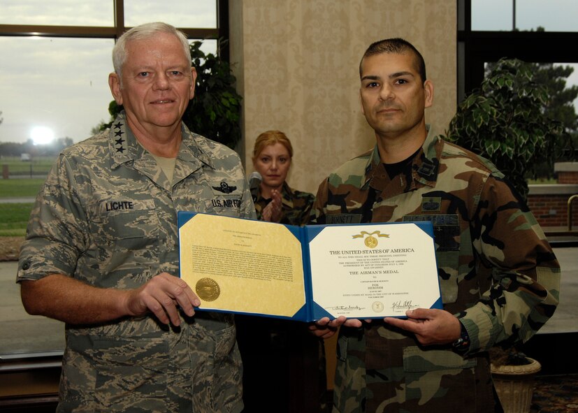 Gen. Arthur Lichte, Air Mobility Command commander, presented Capt. David Burnett, 375th Military Personnel Flight commander, with the Airman’s Medal before a Company Grade Officers’ Council luncheon at the Scott Club on Oct. 22. Captain Burnett received the award for an outstanding act of heroism performed on June 22 when he risked his own life to save the lives of a mother and two small children who were trapped in their vehicle following a massive car accident.   