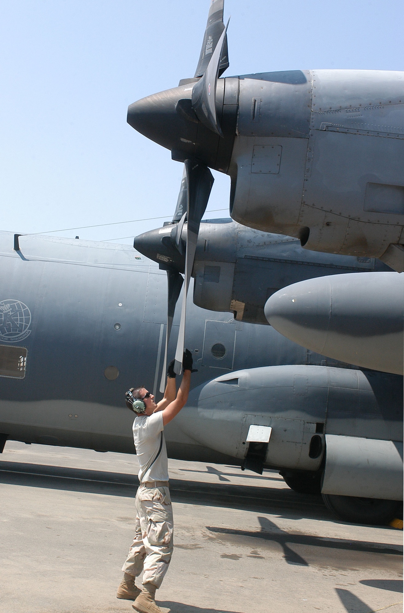 CAMP LEMONIER, Djibouti – Air Force Staff Sgt. Thomas L. Gillespie turns a HC-130P King number one prop blade to the 12 o’clock position after the helicopter-refueling aircraft returned from a flight. The prop is positioned to prevent hydraulic fluid from leaking out of the feedback gear of the blade. The Victorville, Calif., native is an aerospace propulsion craftsman assigned to the 81st Expeditionary Rescue Squadron. He is deployed from Moody Air Force Base, Ga. U.S. Air Force photo by Staff Sgt. Jennifer Redente (RELEASED)    