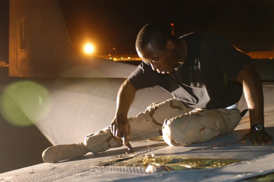 CAMP LEMONIER, Djibouti – Air Force Staff Sgt. Sedquwick S. Bell scraps sealant during a wing spar inspection, which is conducted after every 150 hours of flight. The Staunton, Va., native is a fuel systems repair craftsman assigned to the 81st Expeditionary Rescue Squadron. He is deployed from Moody Air Force Base, Ga. U.S. Air Force photo by Staff Sgt. Jennifer Redente (RELEASED)                            