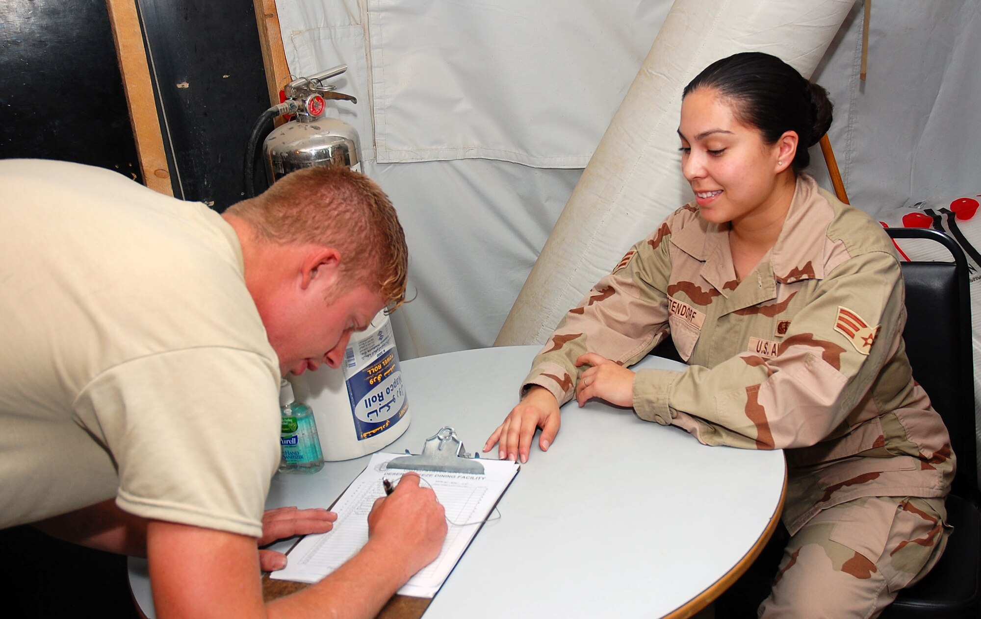 Senior Airman Katrina Westendorf, 386th Expeditionary Services Squadron food services specialist, ensures proper accountability of servicemembers utilizing facility Nov. 2 here.  Airman Westendorf is deployed from Whiteman Air Force Base, Mo. (U.S. Air Force photo/Staff Sgt. Tia Schroeder)
