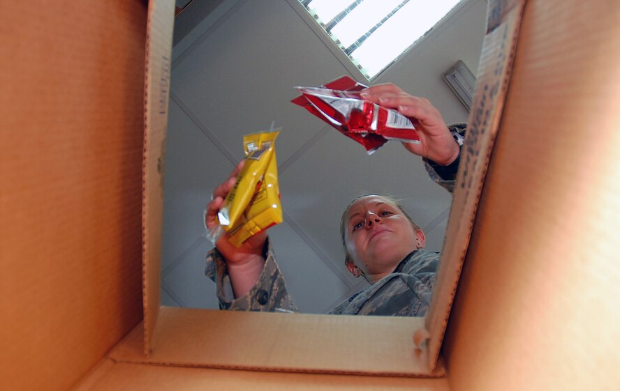 Airman 1st Class Kristen Grow, 386th Expeditionary Services Squadron food services specialist, prepares a flight meal box for flight crew members Nov. 2 here.  Airman Grow is deployed from Barksdale Air Force Base, La. (U.S. Air Force photo/Staff Sgt. Tia Schroeder)