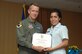 1st Lt Julie Kena accepts his award from Col. Kent Laughbaum, 355th Fighter Wing commander. (Courtesy photo)