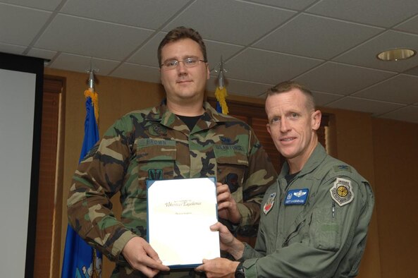 Staff Sgt. Michael S. Brown  accepts his award from Col. Kent Laughbaum, 355th Fighter Wing commander. (Courtesy photo)