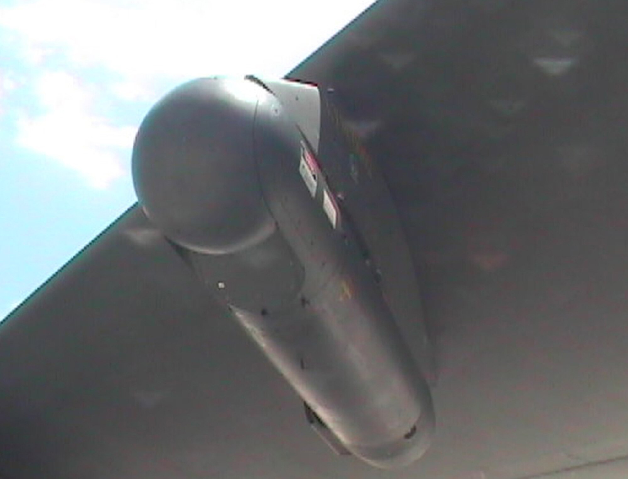 A LITENING pod sits under the wing of a B-52. The 49th Test and Evaluation Squadron's recent demonstration showed the B-52's LITENING pod's capability to capture digital imagery and upload it to communications networks.  U.S. Air Force photo.