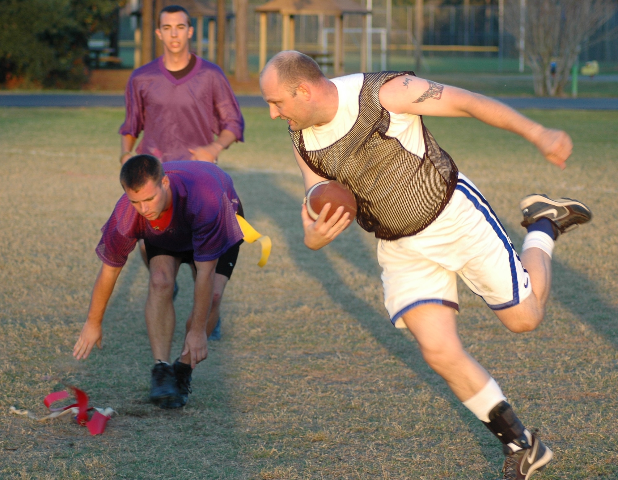 1st Special Operations Civil Engineer Squadron defender Ronald Banks strips the flag from Fire Department running back Jonathan Edie during the first half of the CE-Fire Department flag football game Nov. 1 on the Aderholt field.  CE won the game 34-14.  (U.S. Air Force photo by Master Sgt. Stuart Camp)
