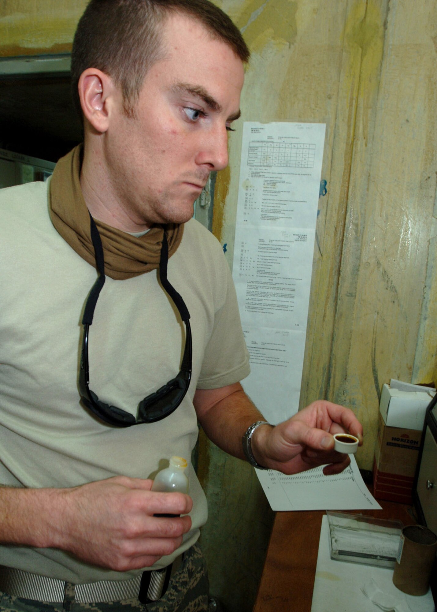 Staff Sgt. Anthony Phillips prepares a sample of engine oil from an A-10C Thunderbolt II to be analyzed by a spectrometer at Al Asad Air Base, Iraq. The spectrometer burns fluids to discover contaminants that would signify wear and tear to the aircraft's engines. Sergeant Phillip is a nondestructive inspections technician with the 438th Expeditionary Aircraft Maintenance Squadron, and is deployed from the Kentucky Air National Guard's 123rd Tactical Airlift Wing. (U.S. Air Force photo/Tech. Sgt. D. Clare)