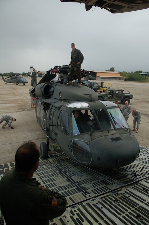 SOTO CANO AIR BASE, Honduras -- Soldiers and Airmen from Joint Task Force-Bravo here check for clearance as a UH-60 Black Hawk helicopter is loaded onto a C-5 Galaxy from the New York Air National Guard.  A team of 19 Airmen and Soldiers and two helicopters from Joint Task Force-Bravo departed here Nov. 5 heading for the Dominican Republic to assist with recovery efforts in the wake of Tropical Storm Noel. (U.S. Air Force photo/Staff Sgt. Austin M. May) 