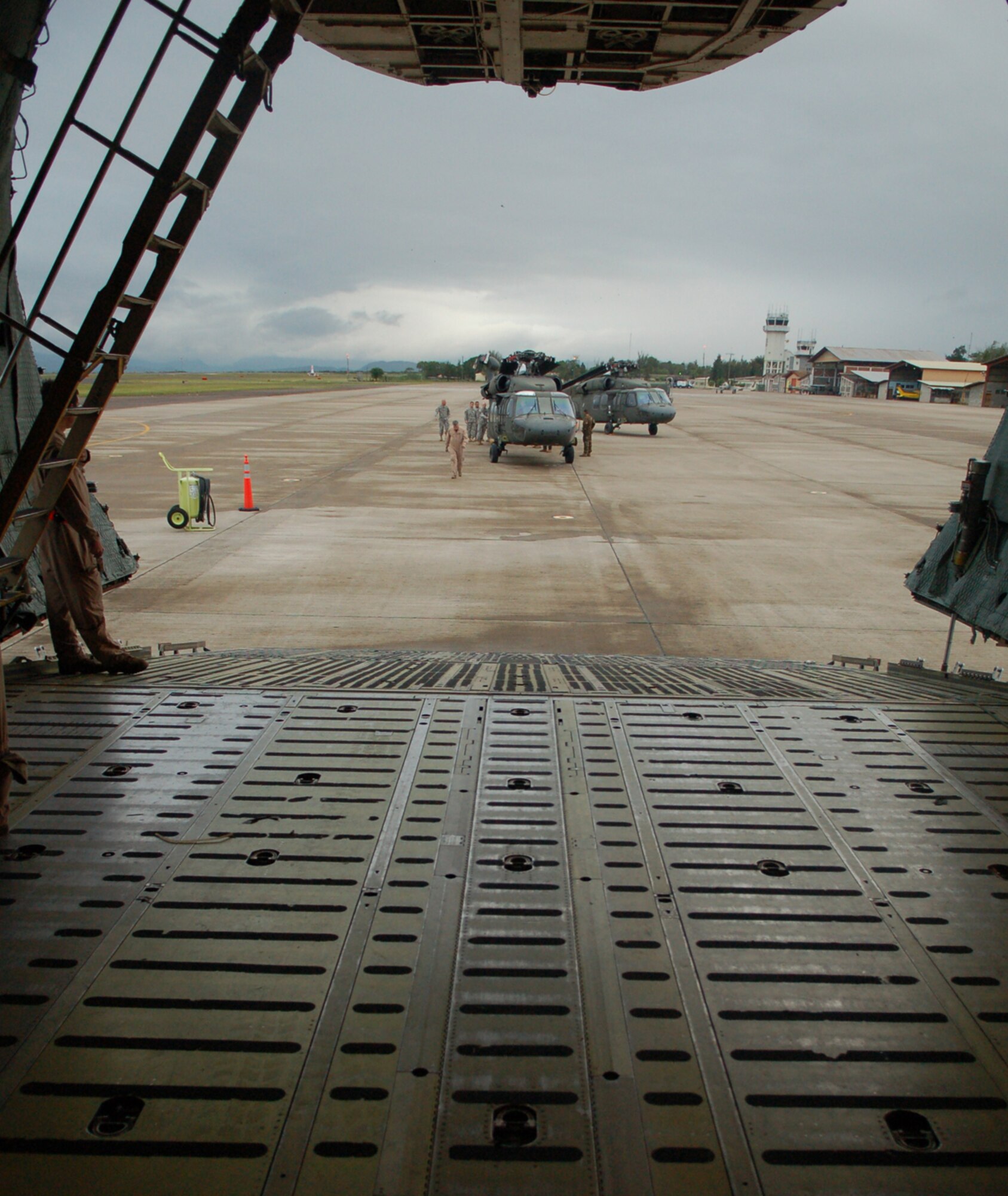 SOTO CANO AIR BASE, Honduras -- Two Army UH-60 Black Hawk helicopters sit on the tarmac here prior waiting to be loaded onto a C-5 Galaxy from the New York Air National Guard.  A team of 19 Airmen and Soldiers and two helicopters from Joint Task Force-Bravo departed here Nov. 5 heading for the Dominican Republic to assist with recovery efforts in the wake of Tropical Storm Noel. (U.S. Air Force photo/Staff Sgt. Austin M. May) 