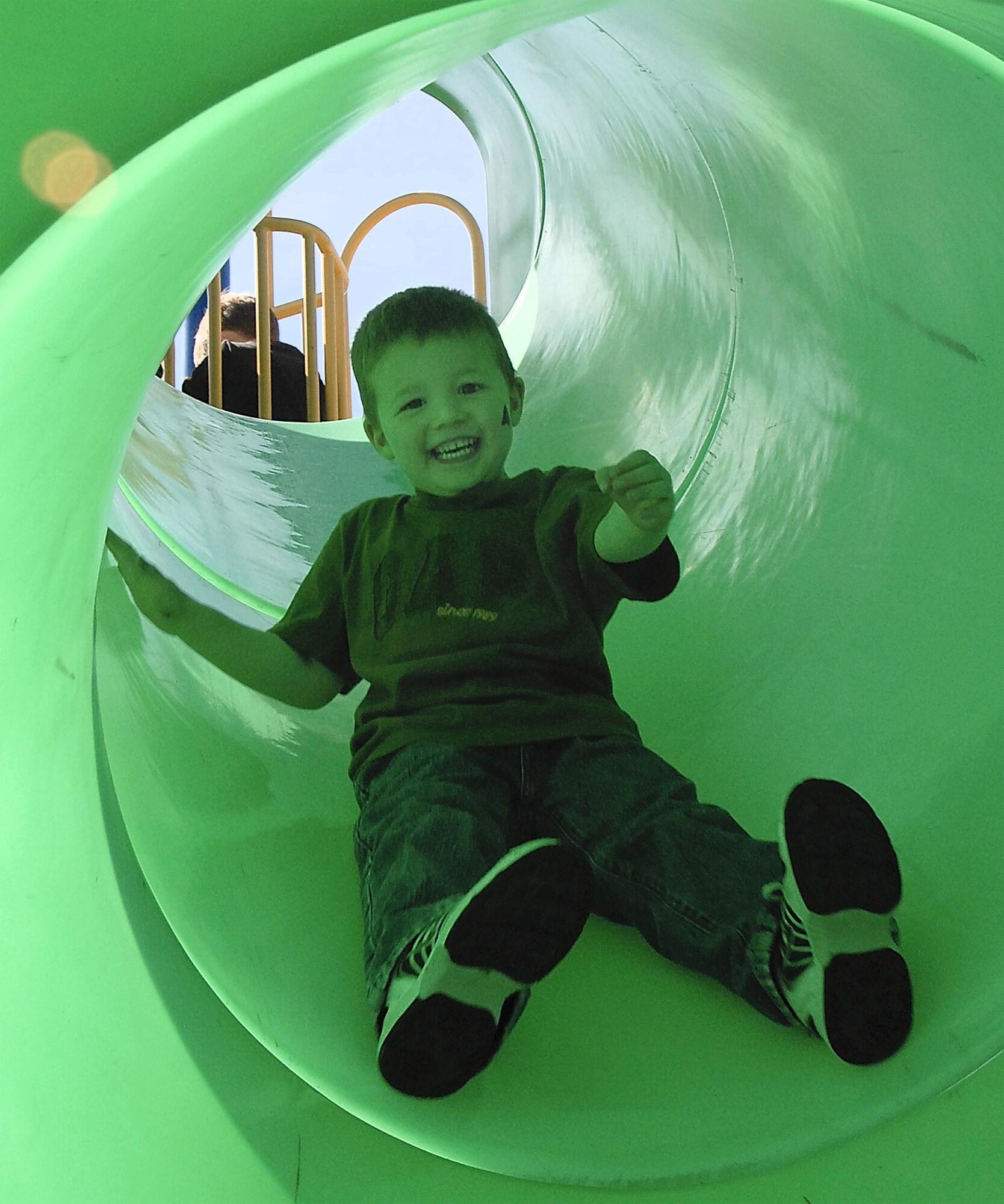 Family fun was the name of the game at the 442nd Fighter Wing's Family Appreciation Day picnic Oct. 14, 2007. Sunlight filtering through a tubular playground slide casts a green tint on one happy picnic goer. The 442nd is an Air Force Reserve Command A-10 Thunderbolt II unit based at Whiteman AFB, Mo.  (US Air Force photo/Master Sgt. Bill Huntington)