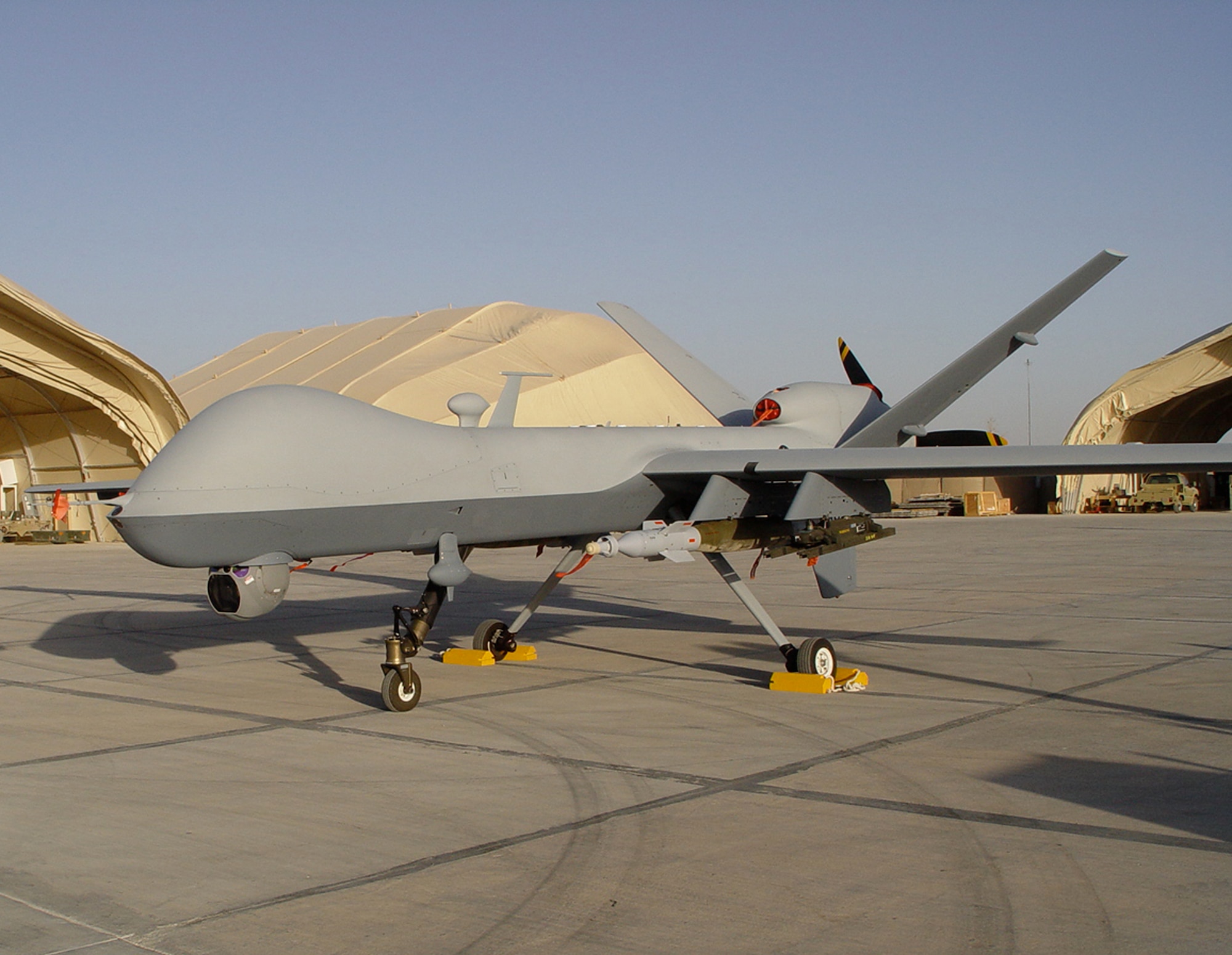 An Air Force MQ-9 Reaper waits for its first mission in a deployed environment on a flightline in Southwest Asia during a deployability test in Sept.  The test was performed by the Air Force Operational Test and Evaluation Center Detachment 5 and the 31st Test and Evaluation Squadron.  (U.S. Air Force photo)