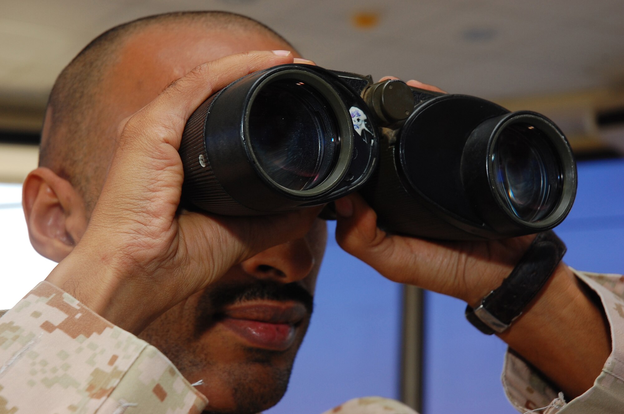 SOUTHWEST ASIA -- Sgt. Abdullah Al. Ajmi, a host nation air traffic controller, scans the horizon for an inbound aircraft Nov. 2 here.  Sergeant Ajmi is responsible for the safe and expeditious flow of air traffic.  (U.S. Air Force photo by Staff Sgt. Tia Schroeder)