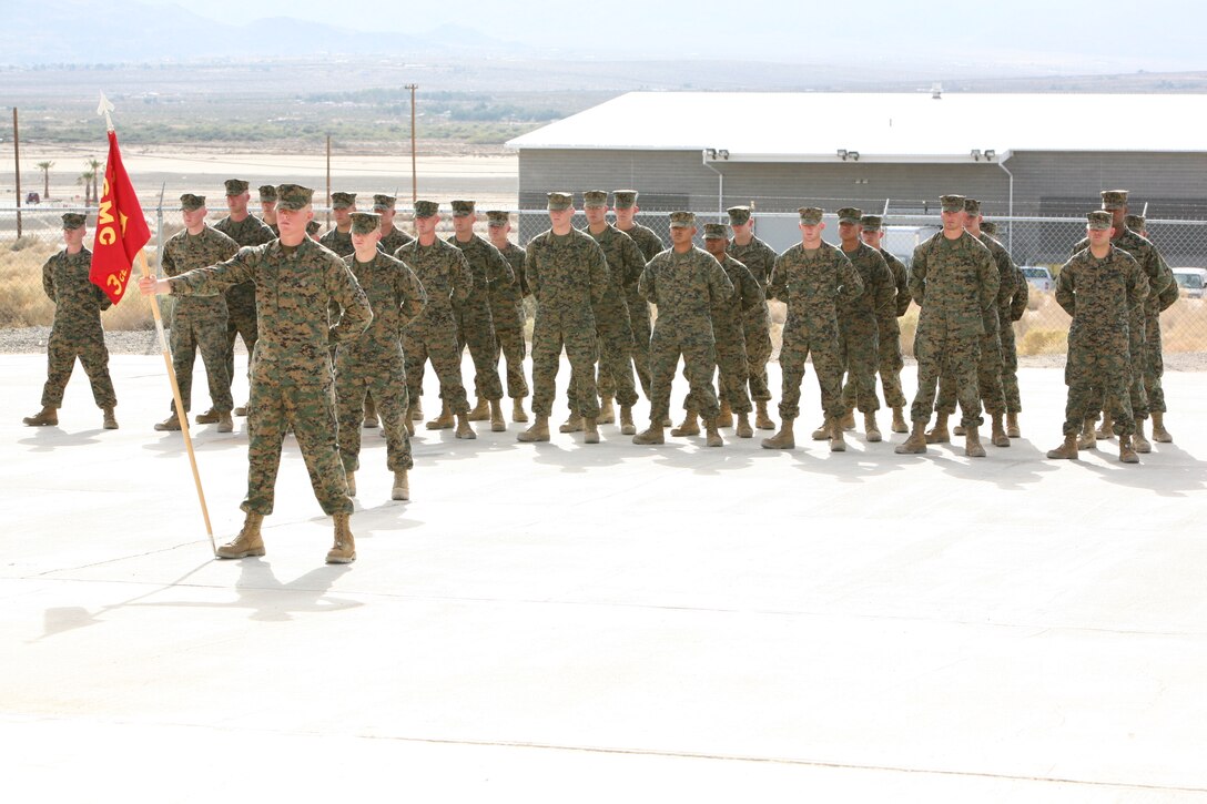 Marines and sailors from Alpha Company, 3rd CEB, stand in formation while their guideon is proudly displayed by the company color bearer at their activation ceremony Monday.