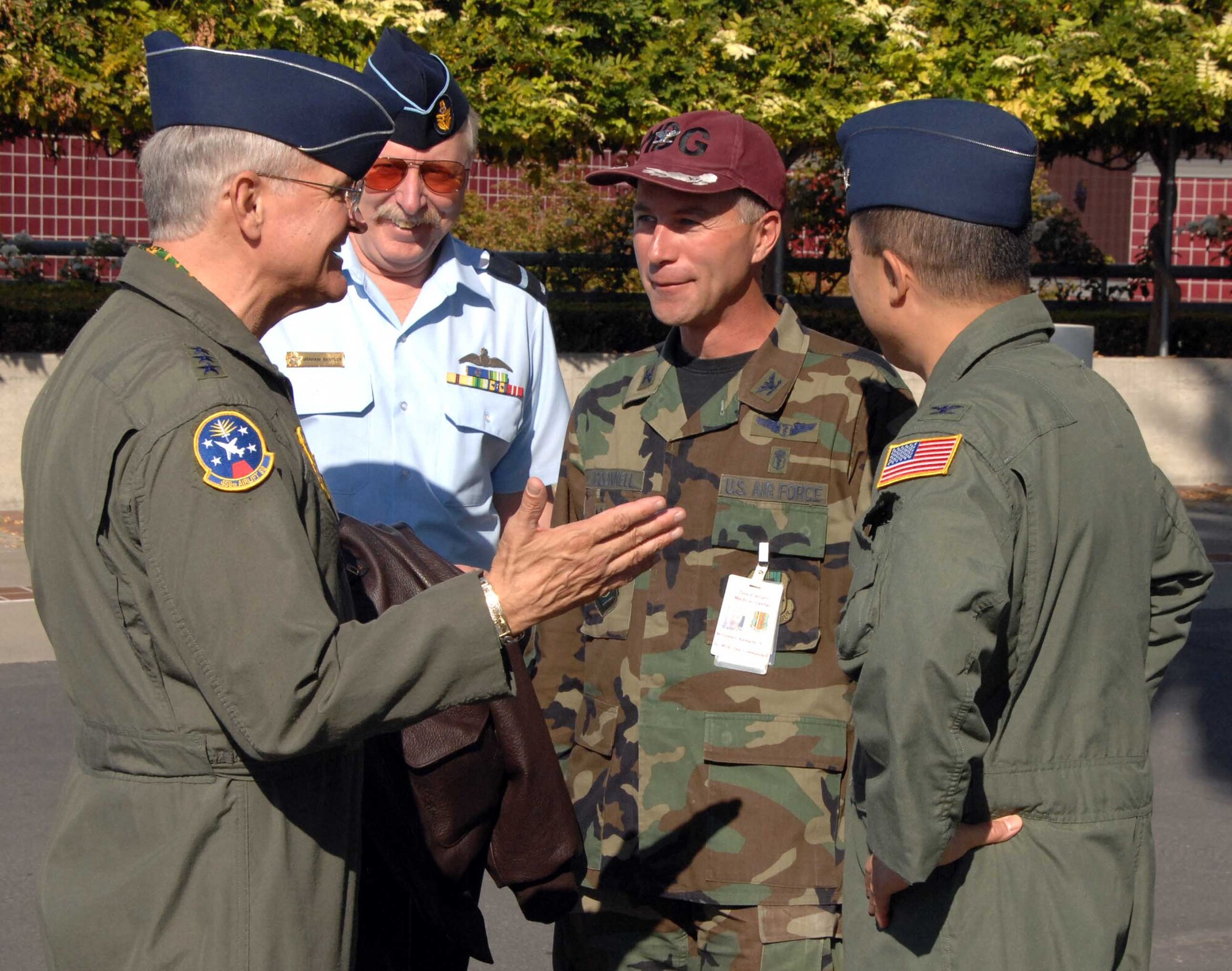 Lt. Gen. Christopher Kelly, Air Mobility Command vice commander, speaks with Col. Kenneth McDonnell, (center), 60th Medical Group deputy commander and Col. GI Tuck, (right), 60th Air Mobility Wing vice commander during his visit to Travis. (U.S Air Force photo/David Cushman)