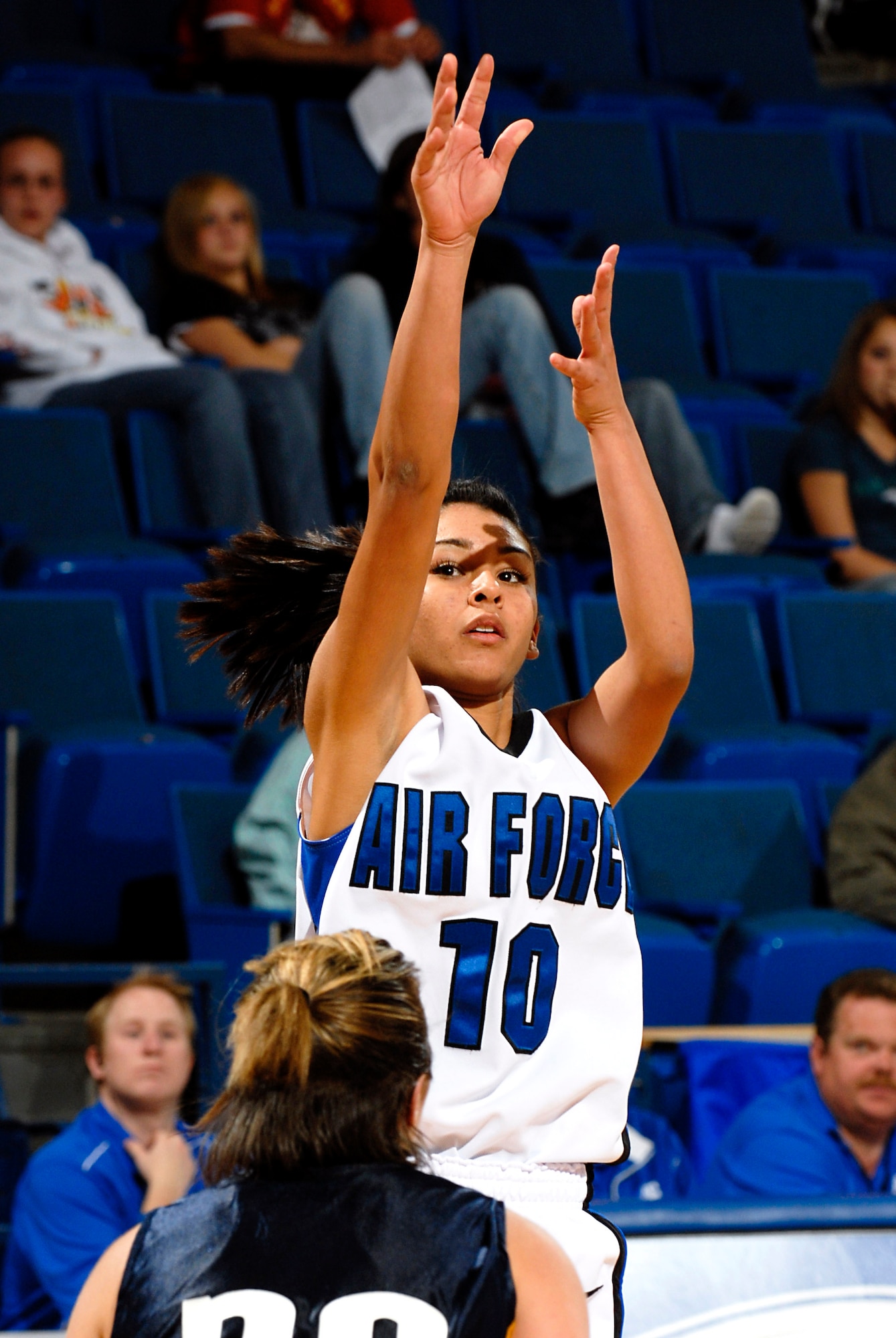 Air Force Academy freshman guard Stevie Puentes takes a jump shot above Regis University's Breanne Burley during the Falcons' 89-52 exhibition win Nov. 3 at the Academy's Clune Arena. Air Force opens its regular season Nov. 9 at Oklahoma State.  (U.S. Air Force photo/Lewis Carlyle)