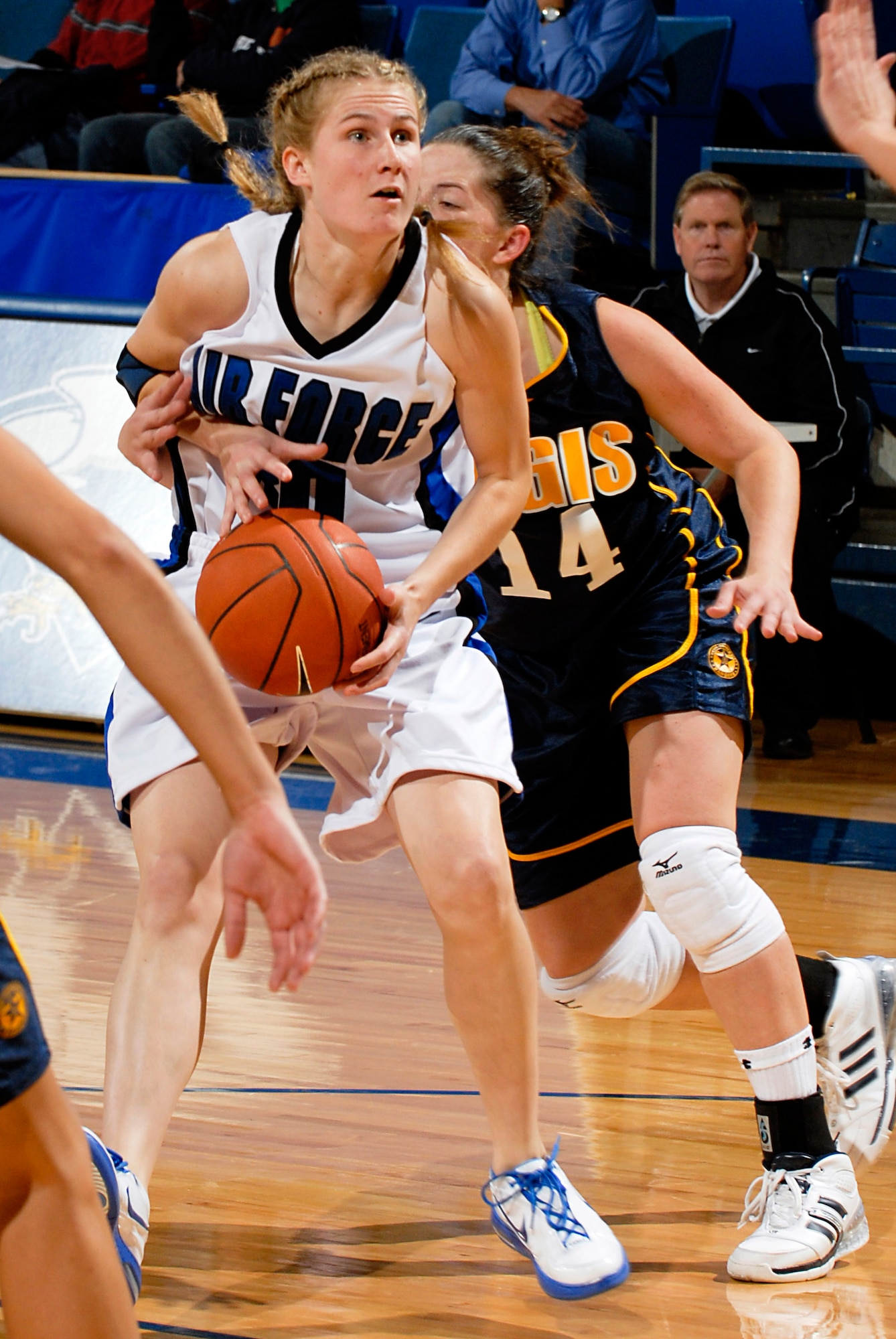 Air Force Academy senior guard Pamela Findlay looks to pass while being defended from behind by Regis University's Stevi Seitz during the Falcons' 89-52 exhibition win Nov. 3 at the Academy's Clune Arena.  Findlay scored 14 points, including 6-of-11 from the floor. The Glenview, Ill., native also grabbed four rebounds and dished out two assists. Air Force opens its regular season Nov. 9 at Oklahoma State.  (U.S. Air Force photo/Lewis Carlyle)