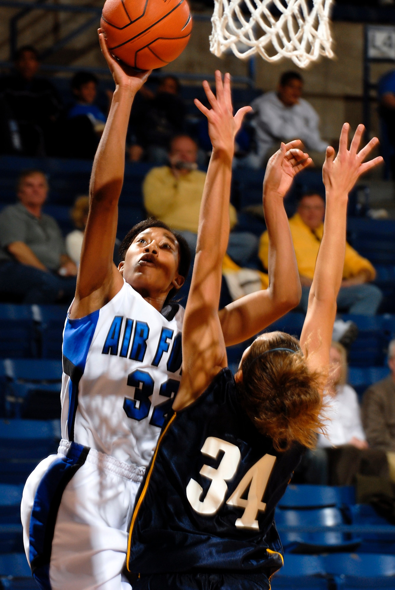 Air Force Academy senior forward Alecia Steele goes  for a lay up above Regis University's Luaren Luebbe during the Falcons'  89-52 exhibition victory Nov. 3 at the Academy's Clune Arena. Steele had a game-high  23 points and 17 rebounds. Air Force opens its regular season Nov. 9 at Oklahoma State. (U.S. Air Force photo/Lewis Carlyle)