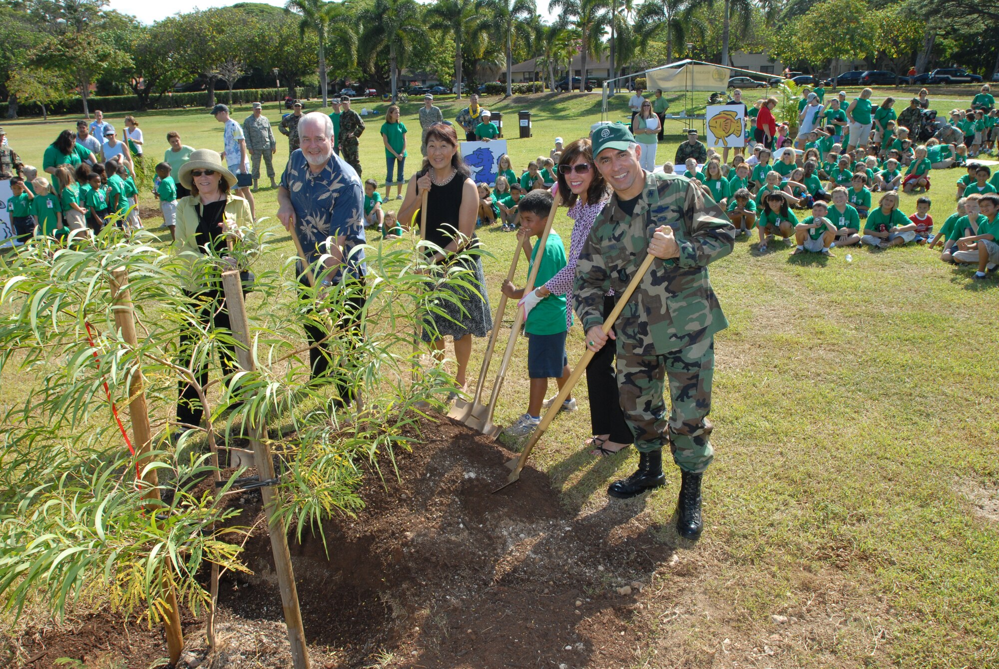 Col. J.J. Torres and his wife, Mrs. Irene Torres help plant the first tree during the Arbor Day celebration. 