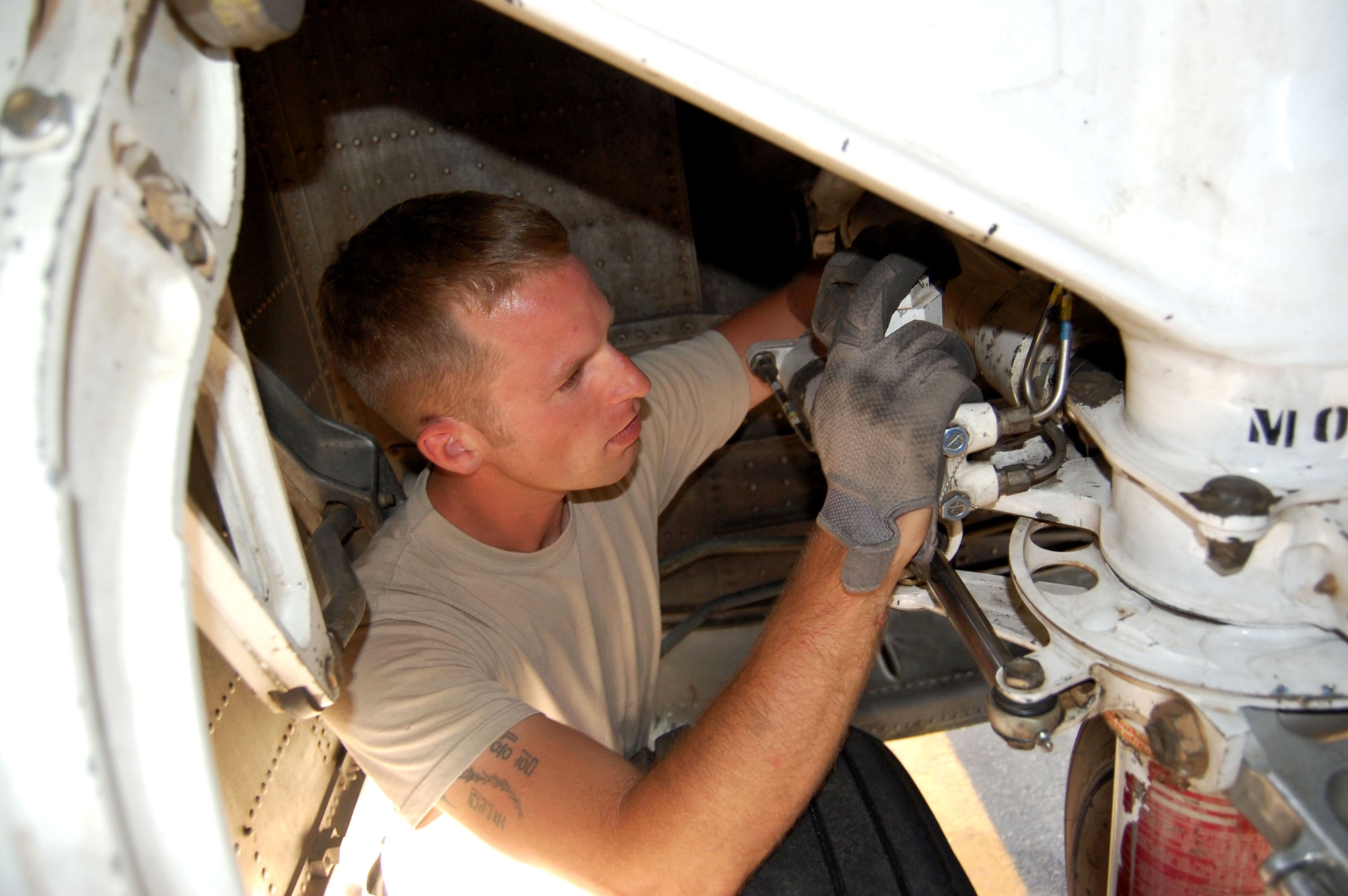 Staff Sgt. Andrew Baker inspects a nose wheel steering actuator Oct. 30 in Southwest Asia. Assigned to the 386th Expeditionary Aircraft Maintenance Squadron, Sergeant Baker is the crew chief for a C-130 known a "grandpa," an aircraft built in 1961. (U.S. Air Force photo/Staff Sgt. Phillip Butterfield)