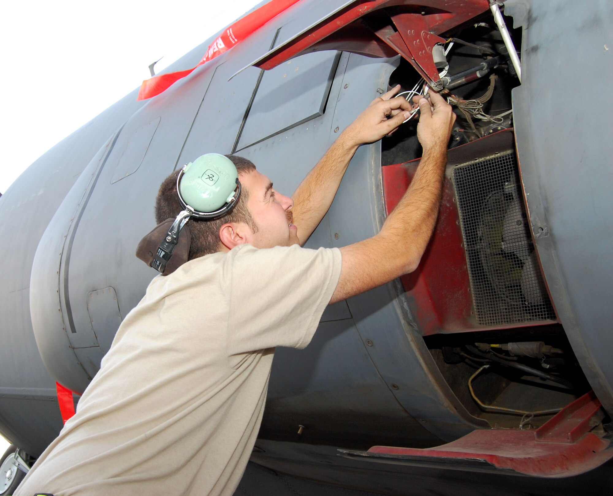 Tech. Sgt. James Vehlies inspects wires for possible chaffing Oct. 30 in Southwest Asia. Some of the oldest C-130s in the Air Force fleet fly missions in support of operations Iraqi and Enduring Freedom. Sergeant Vehlies is an electro-environmental systems craftsman with the 43rd Expeditionary Electronic Combat Squadron. (U.S. Air Force photo/Staff Sgt. Phillip Butterfield)