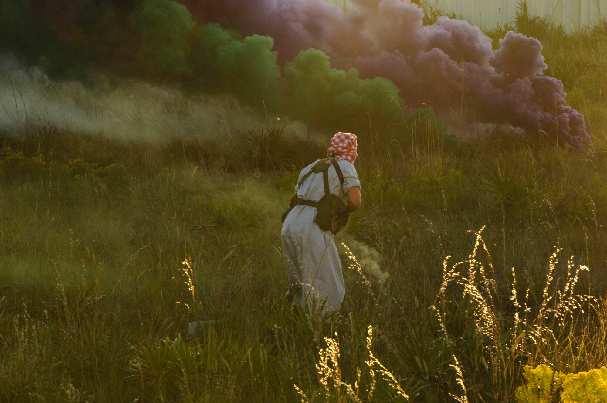 An Air Force servicemember portraying an enemy insurgent approaches an Army position obscured by colored smoke during Atlantic Strike VI, a semi-annual training event sponsored by U.S. Central Command Air Forces in the Avon Park Air Ground Training Complex in Avon Park, Fla.  The intense Atlantic Strike training scenarios are aimed at preparing Joint Terminal Attack Controllers and Army Joint Fires Observers for urban close air support operations prior to deployment to Iraq and Afghanistan.  Atlantic Strike battles continue through 9 Nov. (U.S. Air Force Photo By Airman 1st Class Stephenie Wade)