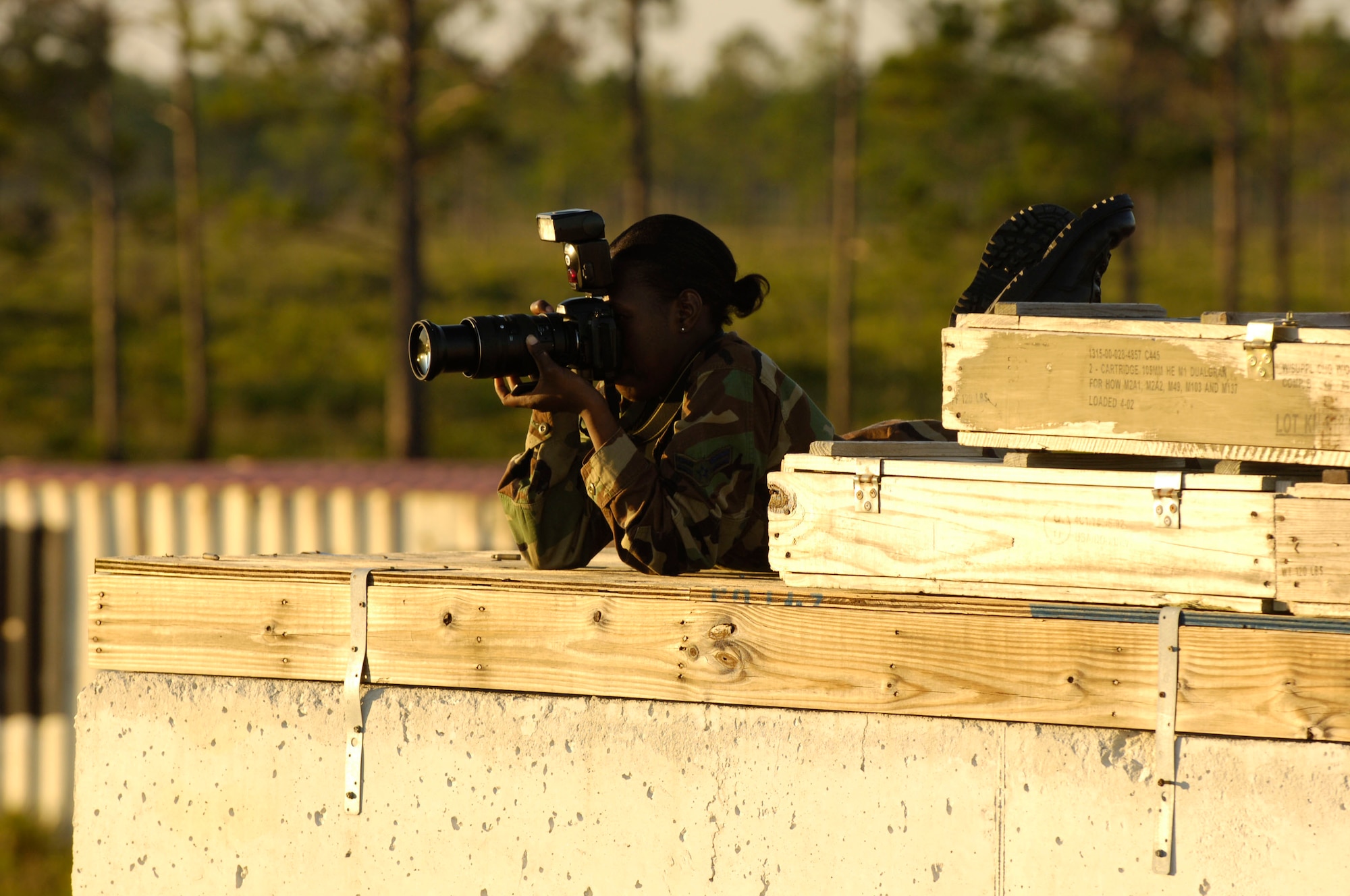 Airman 1st Class Latanya Reid, a Public Affairs apprentice journalist, focuses her camera on military members during Atlantic Strike VI at the Avon Park Air Ground Training Complex in Avon Park, Fla.  The semi-annual training event is sponsored by U.S. Central Command Air Forces to prepare Joint Terminal Attack Controllers and Army Joint Fires Observers for urban close air support operations prior to deployment to Iraq and Afghanistan.  Atlantic Strike battles continue through 9 Nov.  (U.S. Air Force Photo By Airman 1st Class Stephenie Wade)