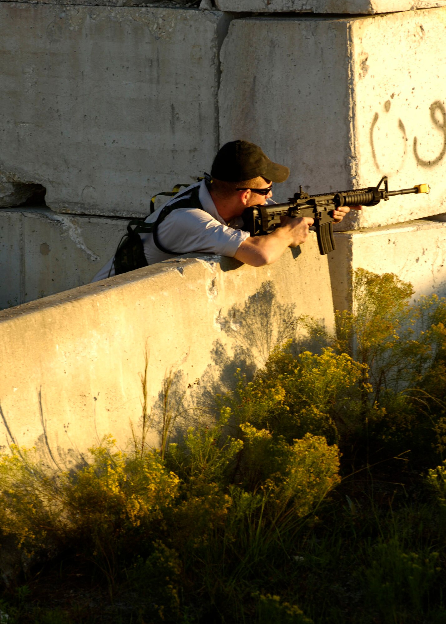Airman Josh Lacki; a Tactical Air Control Party member from the 11th Air Support Operations Squadron at Ft. Hood; Tex.; prepares to fire at "enemy" troops during Atlantic Strike VI in Avon Park; Fla.; Airman Lacki is acting as opposition forces during the exercise to challenge Joint Terminal Attack Controllers working with Army platoons to use airpower in urban close air support operations.; The exercise is scheduled to last through Nov. 9th. (U.S. Air Force Photo By Airman 1st Class Stephenie Wade)