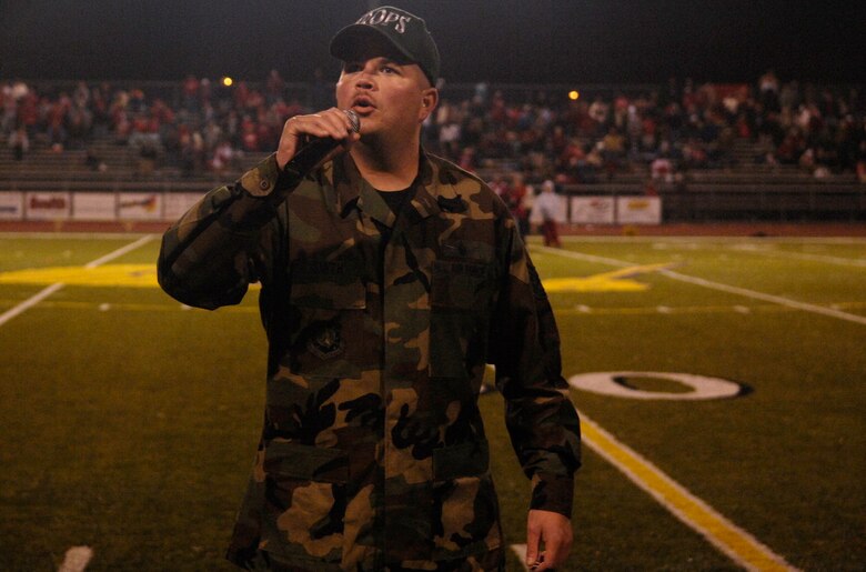 SANTA MARIA, Calif. -- Tech. Sgt. Chad Smith, 2nd Range Operations Squadron, sings "America the Beautiful" during halftime for the game between the Allan Hancock Bulldogs and Bakersfield Renegades at the 5th annual military appreciation night on Nov. 3. The Bulldogs lost 23-36. Military appreciation night was held for all military members who have made sacrifices to protect their country. The first 250 military members, veterans and their families were admitted at no charge and served a free tri-tip dinner. The Santa Maria Valley Chamber of Commerce, Coast Hills Federal Credit Union, and Allan Hancock College sponsored the special event. (U.S. Air Force photo/Airman 1st Class Christian Thomas)