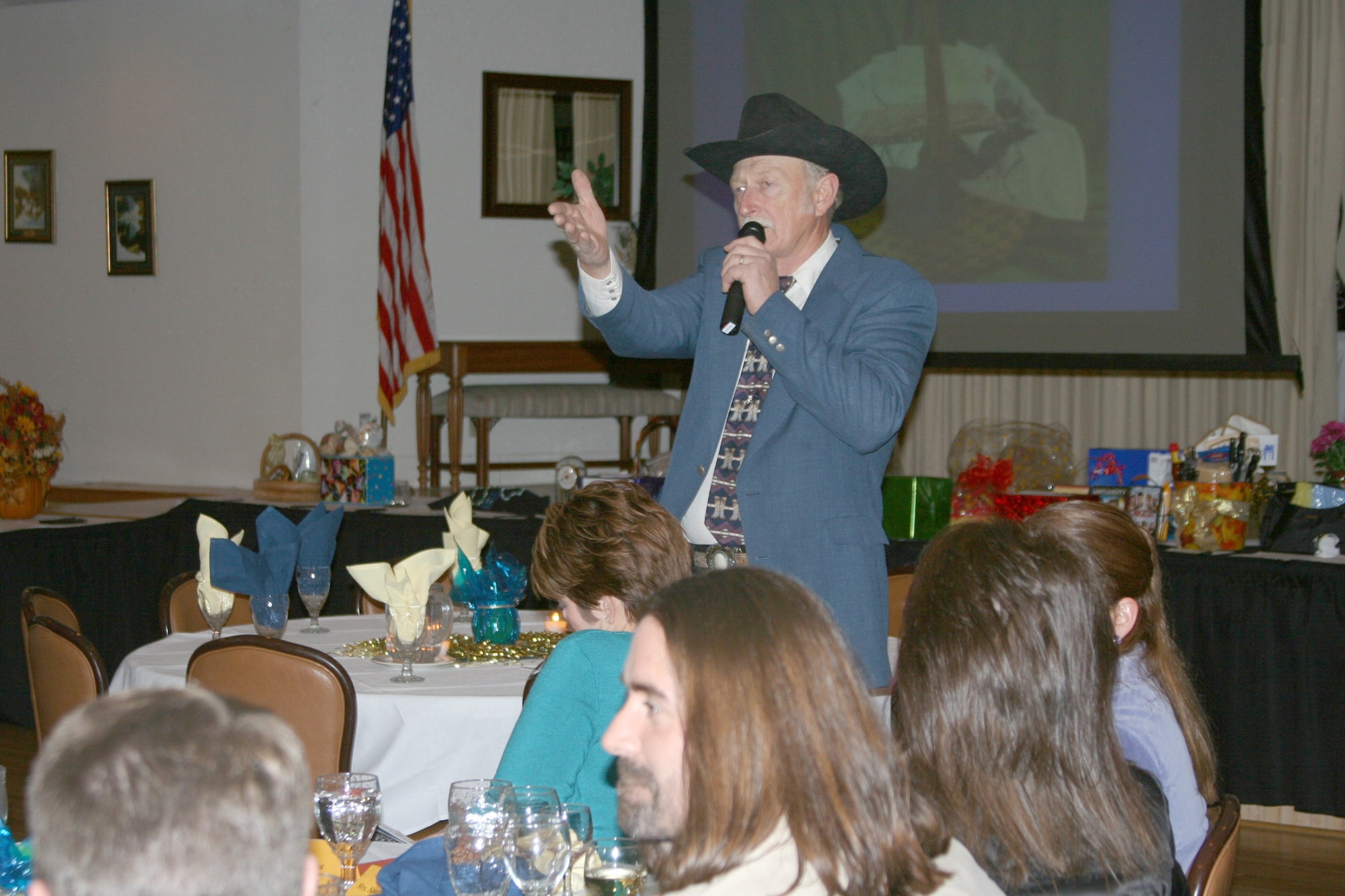 Fred Burow, a Great Falls resident, is the auctioneer at the 19th Annual Mercantile Auction Nov. 3 at the Grizzly Bend Club. The auction is a yearly event hosted by the Malmstrom Spouses' Club and proceeds benefit scholarships and local charities. This is Mr. Burow's 16th year participating as the auctioneer. (U.S. Air Force photo/Senior Airman Eydie Sakura)