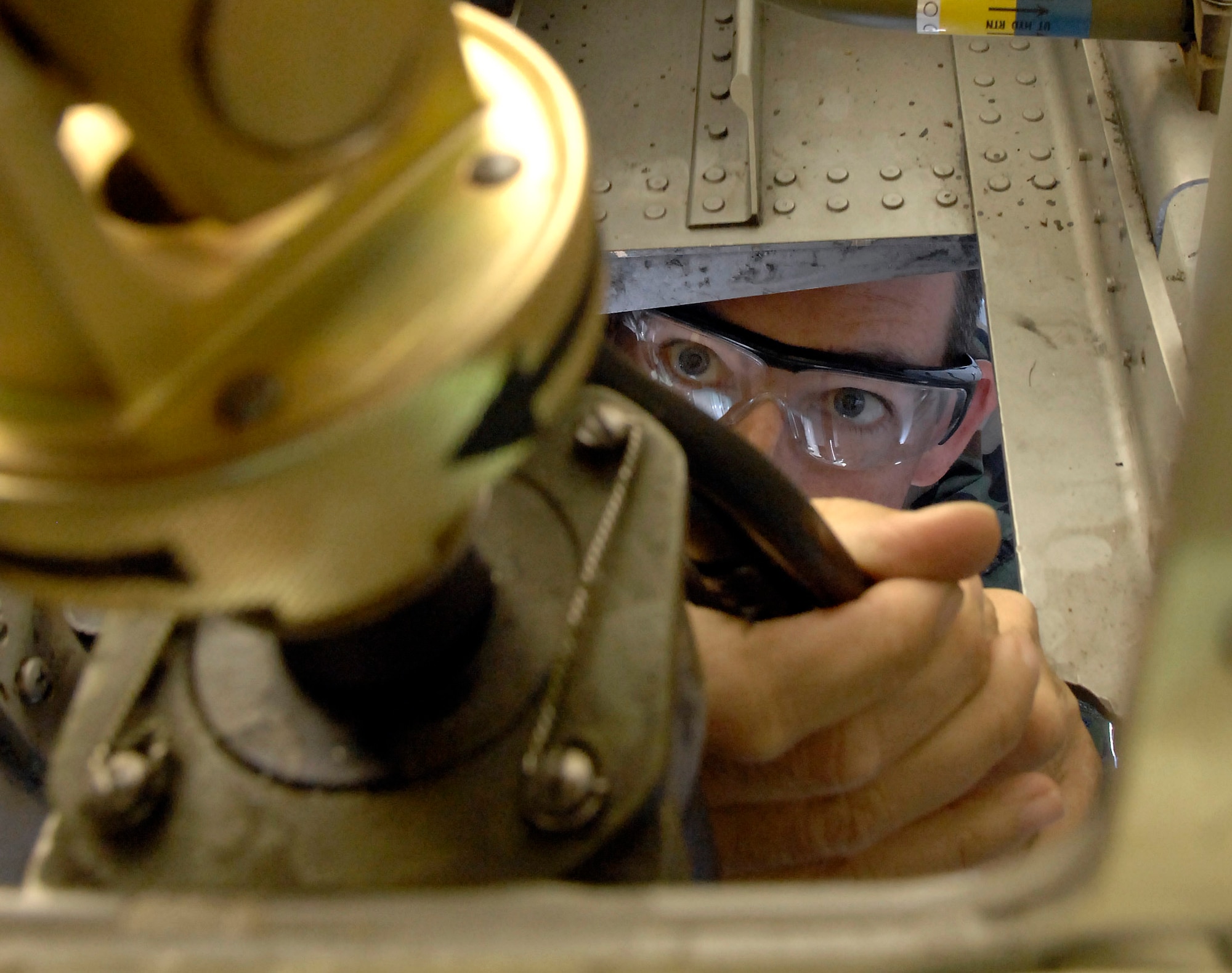 Tech. Sgt. Shawn Taillon, instructor crew chief, wires the quick-disconnect for the main landing gear on the C-130 model trainer at Little Rock, Air Force Base, Ark., Nov. 1. In emergency situations, this allows the crew to drop the landing gear if the manual hand crank is not working. Sergeant Taillon is an instructor crew chief. (U.S. Air Force photo/Tech. Sgt. Larry A. Simmons)