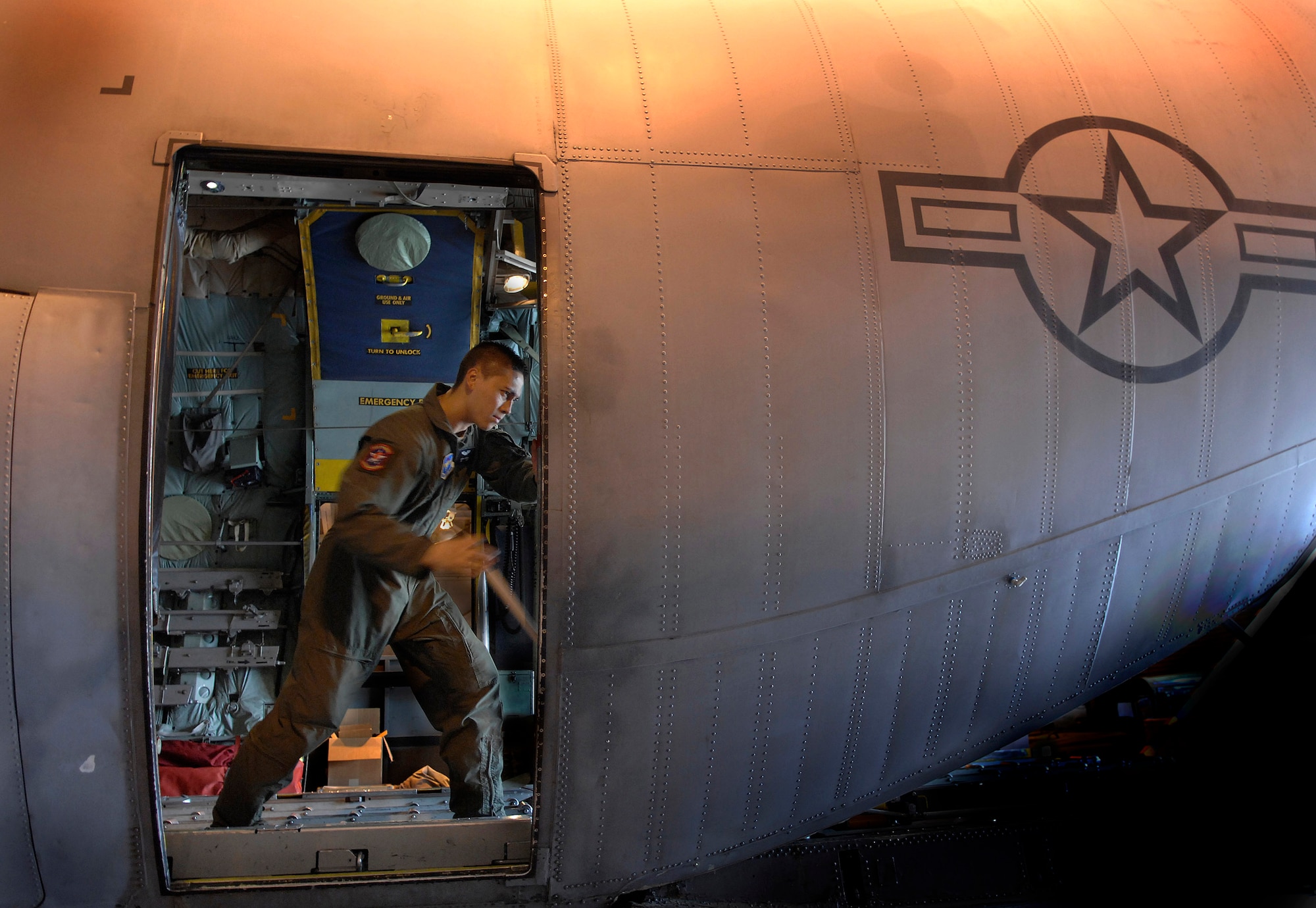 Airman 1st Class Justin Magno manually hand cranks the ramp on a fuselage trainer during upgrade training on the C-130 model trainer at Little Rock Air Force Base, Ark., Nov. 1. The trainers are C-130 models that have had the wings taken off to allow students to train on the actual hardware. Airman Magno is a student with the C-130 Center of Excellence. (U.S. Air Force photo/Tech. Sgt. Larry A. Simmons) 