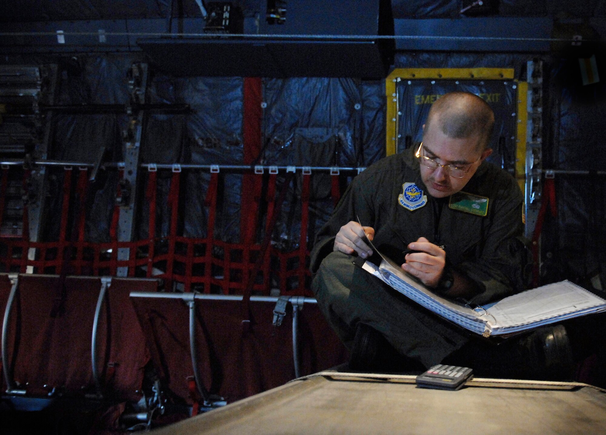 Staff Sgt. Randall Sheppard figures out temperature and weight for take off and landing data on a C-130 Hercules at Little Rock Air Force Base, Ark., on Oct. 31. Sergeant Sheppard is a flight engineer in training. (U.S. Air Force photo/Tech. Sgt. Larry A. Simmons) 