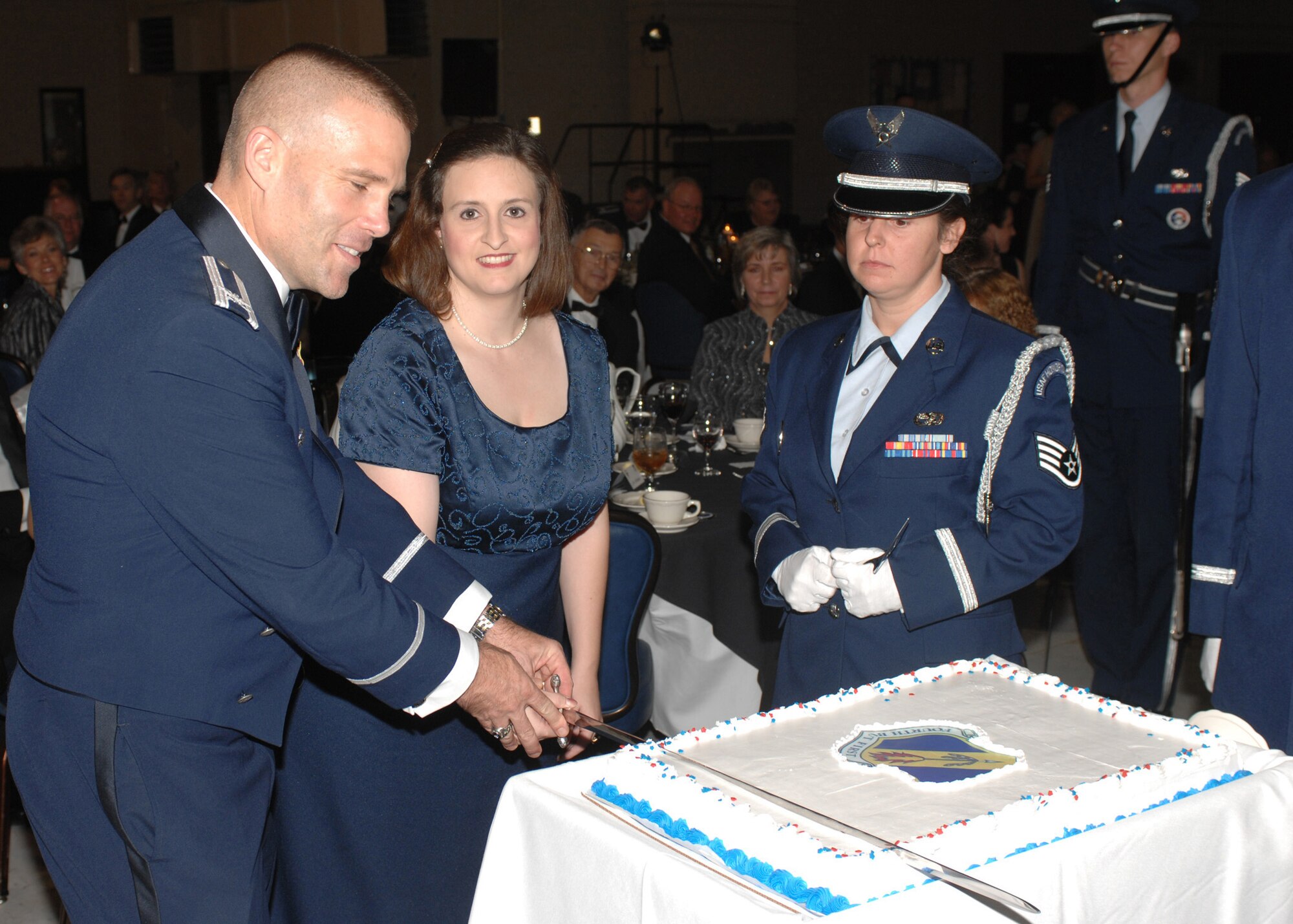 SEYMOUR JOHNSON AIR FORCE BASE, N.C. -- 4th Fighter Wing commander Col. Steve Kwast (left) and Jennifer Ward cut a cake at the Air Force ball on Nov. 3 , Mrs. Ward earned special recognition at the ball for being the spouse of the Team Seymour Airman who has been deployed the longest . The ball celebrated 60 years of air power. (US Air Force photo by Airmen First Class Ciara Wymbs)