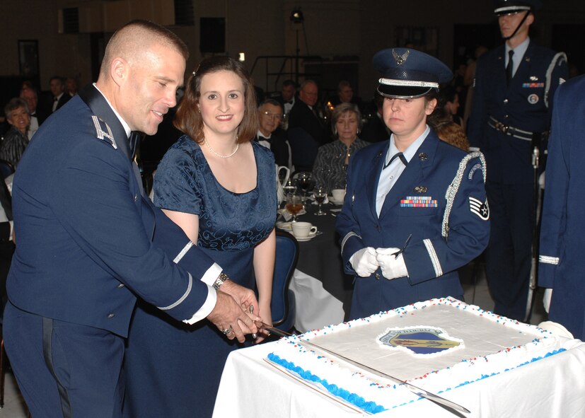 SEYMOUR JOHNSON AIR FORCE BASE, N.C. -- Fourth Fighter Wing commander Col. Steve Kwast (left) and Jennifer Ward cut a cake at the Air Force ball Nov. 3 , Mrs. Ward earned special recognition at the ball for being the spouse of the Team Seymour Airman who has been deployed the longest. The ball celebrated 60 years of air power. (U.S. Air Force photo by Airman 1st Class Ciara Wymbs) 