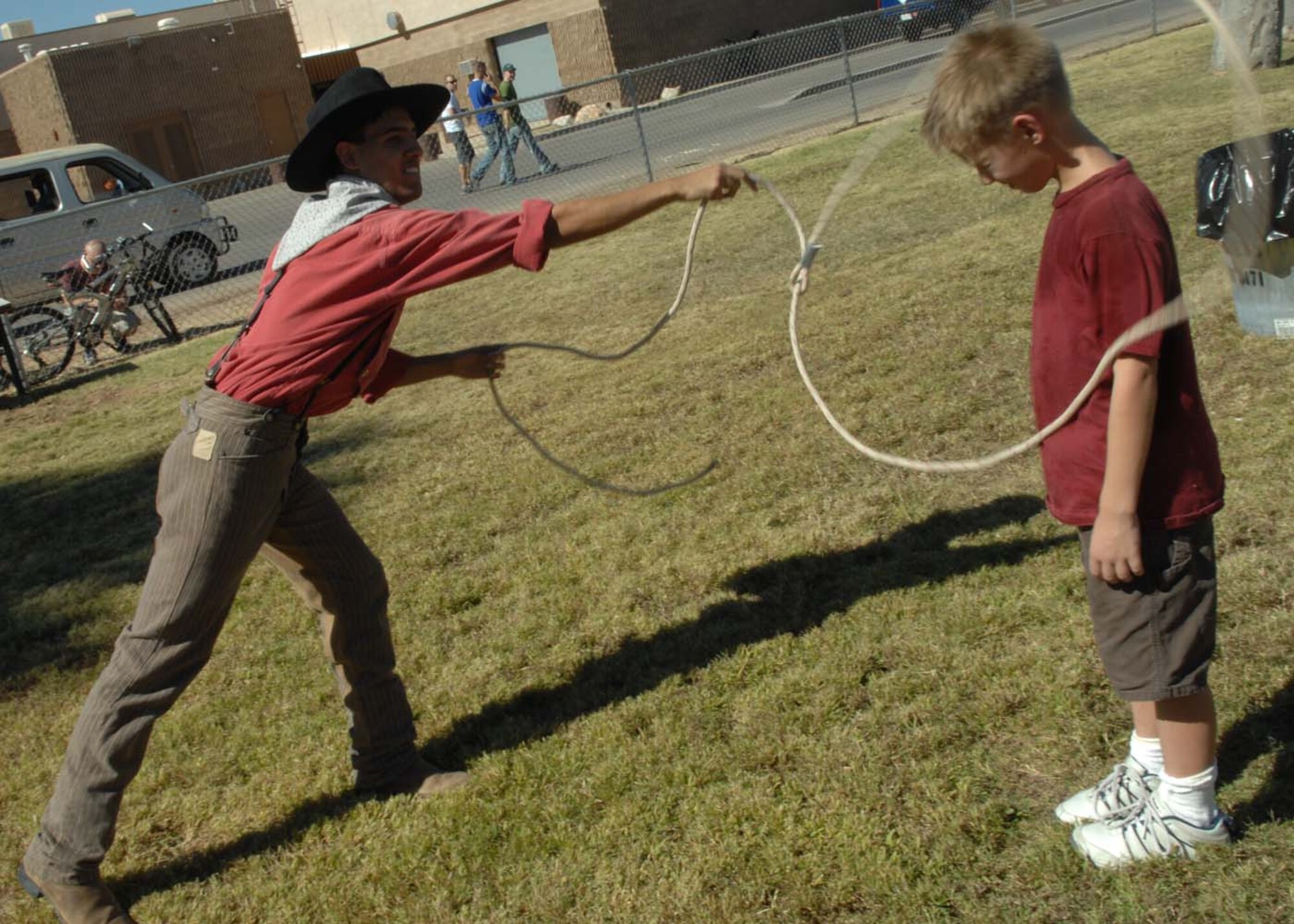 Preston, 8, son of Shannon and Maj. Peter Lommen, 355th Component Maintenance Squadron commander, learns different roping techniques from Willy Aldez, Pinnacle Peak performer Oct. 27, 2007 during the DM-50 picnic at Bama Park.  (U.S. Air Force photo by Senior Airman Christina D. Kinsey)