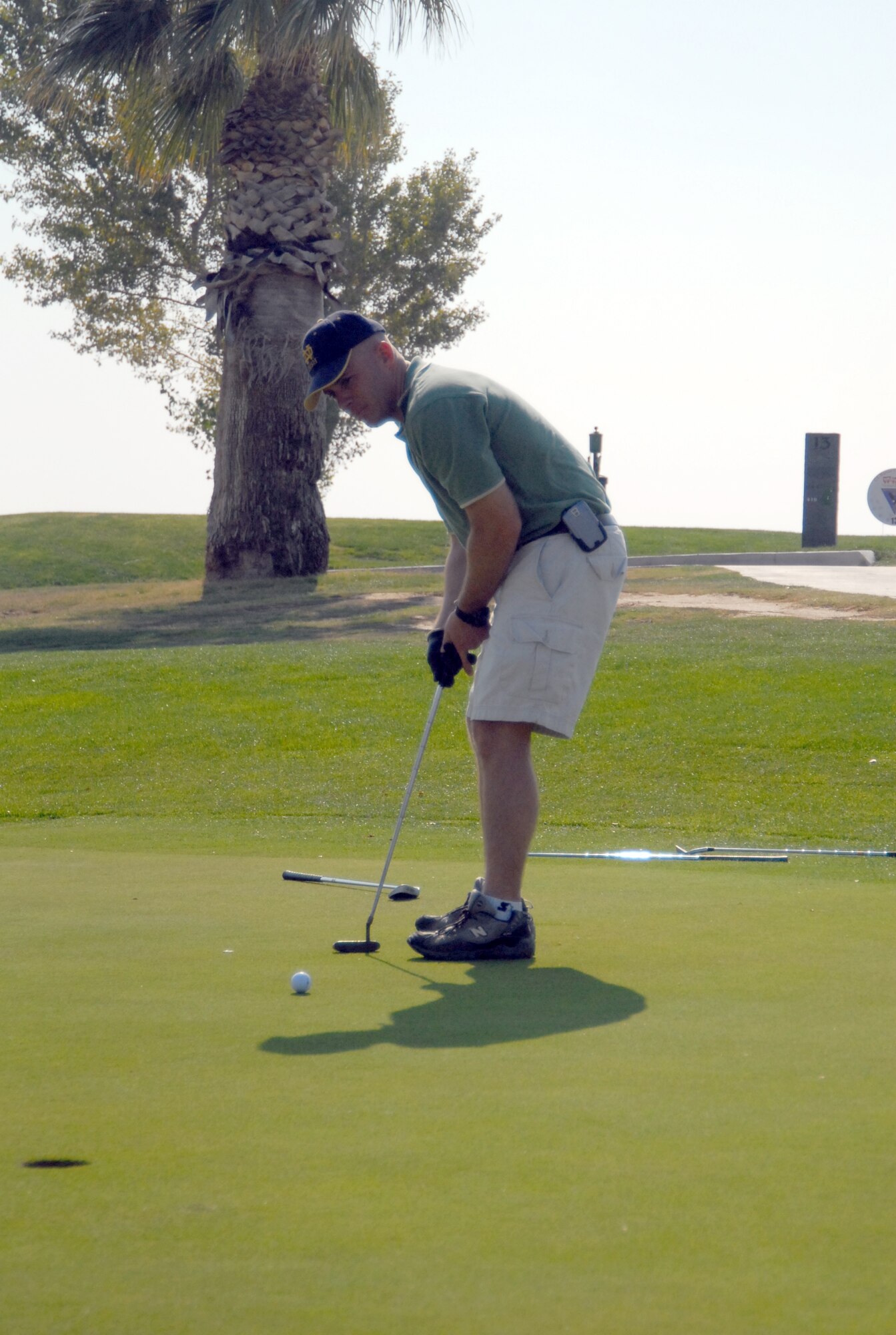 Marine Lt. Col. Thomas McCarthy, Marine Aircraft Group 46 Detachment Bravo commanding officer, makes a putt during the Toys for Tots kickoff golf tournament Oct. 26 at the Muroc Lake Golf Course here. (Photo by Senior Airman Julius Delos Reyes)
