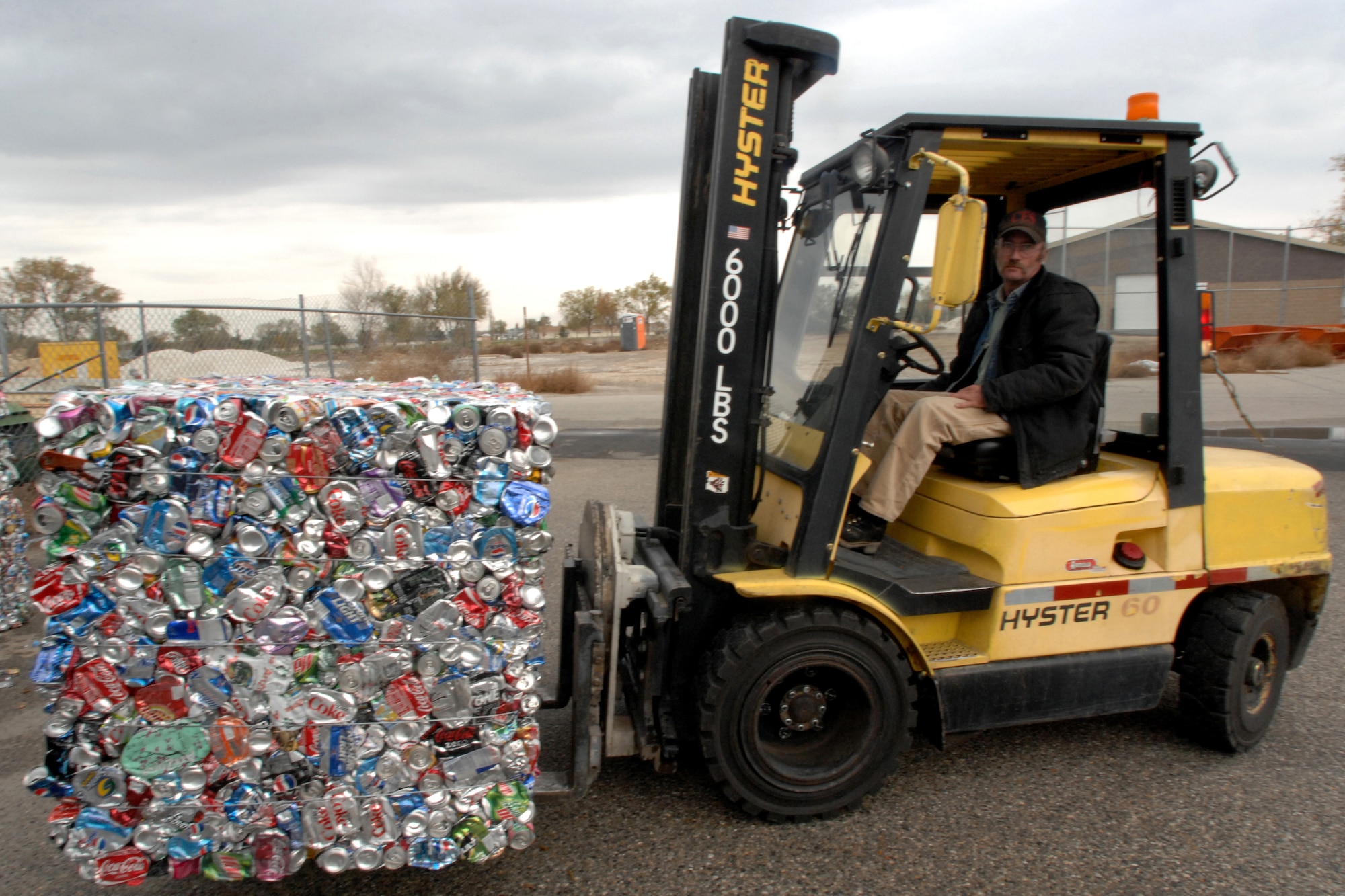 MOUNTAIN HOME AIR FORCE BASE, Idaho - Brent Richter, 366th Civil Engineer Squadron, moves a pile of aluminum cans for recycling at the base recycling center Oct. 30. America Recycles Day, which is celebrated Nov.15, has grown to include millions of Americans including Gunfighters pledging to increase their recycling habits at home and work and to buy products made with recycled materials. (U.S Air Force photo by Airman 1st Class Stephany Miller)