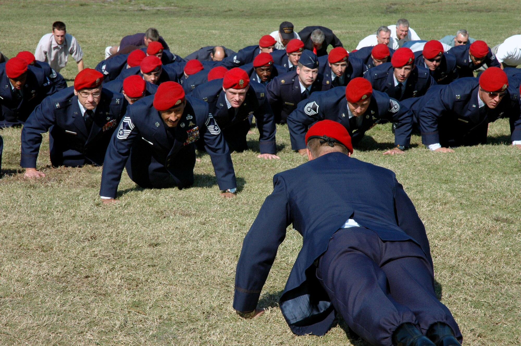 Col. Marc Stratton leads a flight of current and retired combat controllers in memorial push-ups during the Annual Combat Control Association reunion and memorial service Nov. 3 at Hurlburt Field, Fla. More than 100 people gathered for the ceremony to honor their fallen comrades. Colonel Stratton is the 720th Special Tactics Group commander. (U.S. Air Force photo/Dawn Hart)

