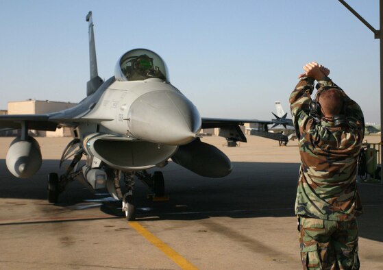 Senior Airman Jeremy Meyers, 34th Fighter Squadron crew chief, prepares Lt. Col. Kurt Gallegos, 419th Fighter Wing pilot, for launch. Reserve pilots and maintainers from the 419th FW now work alongside active duty Airmen from the 388th FW as part of the Air Force?s Total Force Integration initiative aimed at increasing combat capabilities and efficiencies among like units. Total Force Integration between Hill?s fighter wings is the Air Force test case for future fighter associate programs.