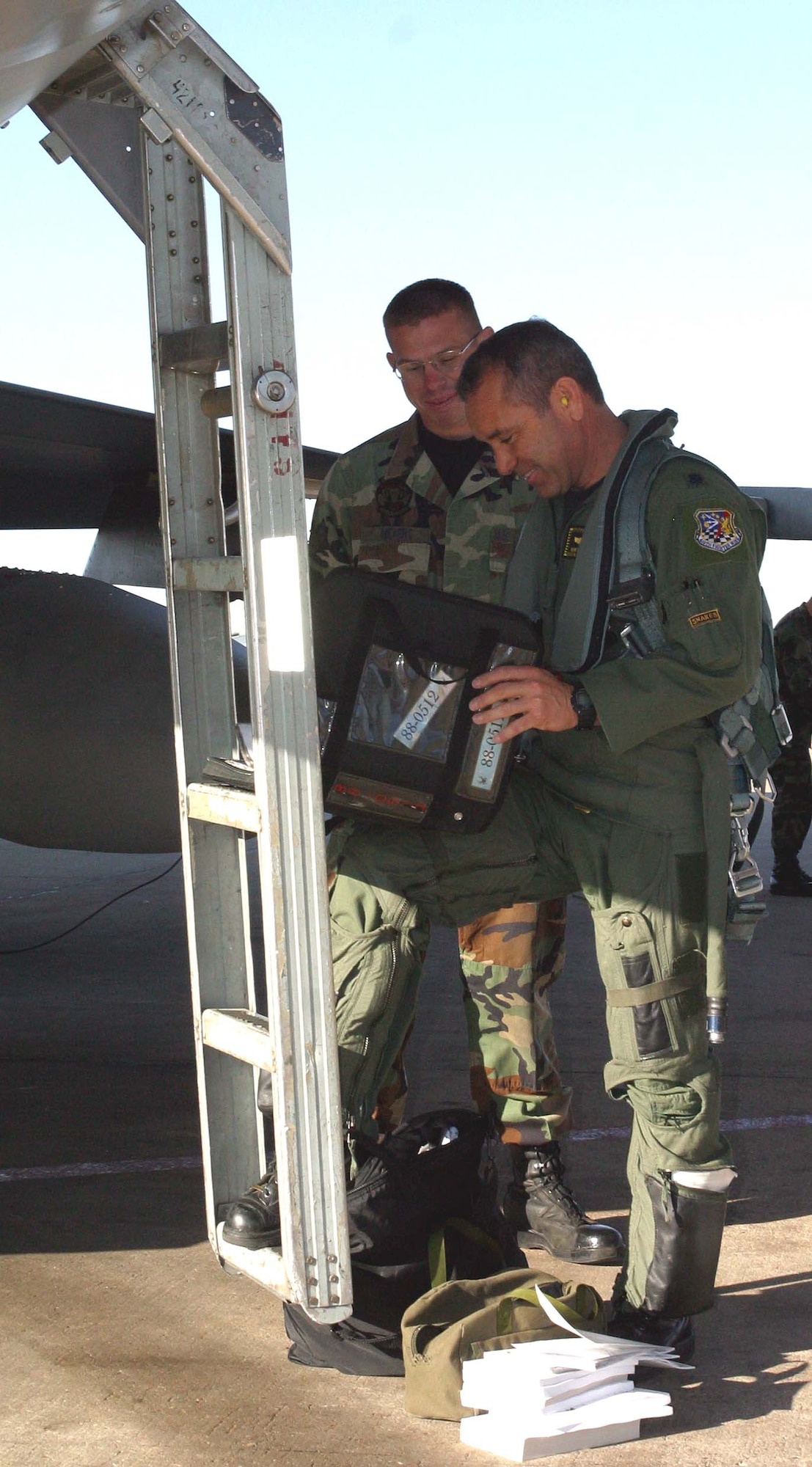 Senior Airman Jeremy Myers and Lt. Col. Kurt Gallegos greet each other and go over procedures before flight.