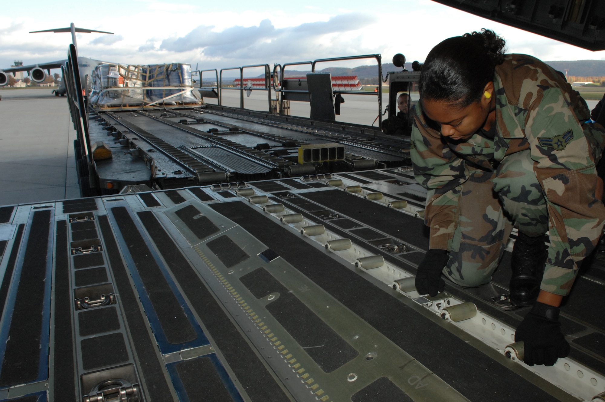 Airman 1st Class Chelsea Marshall, 723rd Air Mobility Squadron, prepares to unload cargo off a C-17 November 6, 2007, Ramstein Air Base, Germany. The 723rd AMS recently received an 'Excellent' rating from the Logistics Standardization and Evaluation Team. (U.S. Air Force photo/Airman 1st Class Amber Bressler)(RELEASED)