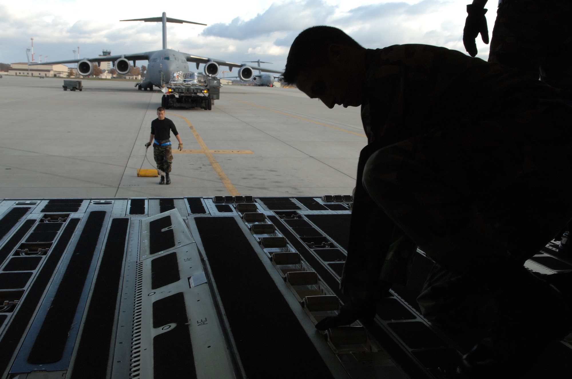 Airman 1st Class Joshua Markle, 723rd Air Mobility Squadron, prepares to unload cargo off of a C-17 November 6, 2007, Ramstein Air Base, Germany. The 723rd AMS recently received an 'Excellent' rating from the Logistics Standardization and Evaluation Team. (U.S. Air Force photo/Airman 1st Class Amber Bressler)(RELEASED)