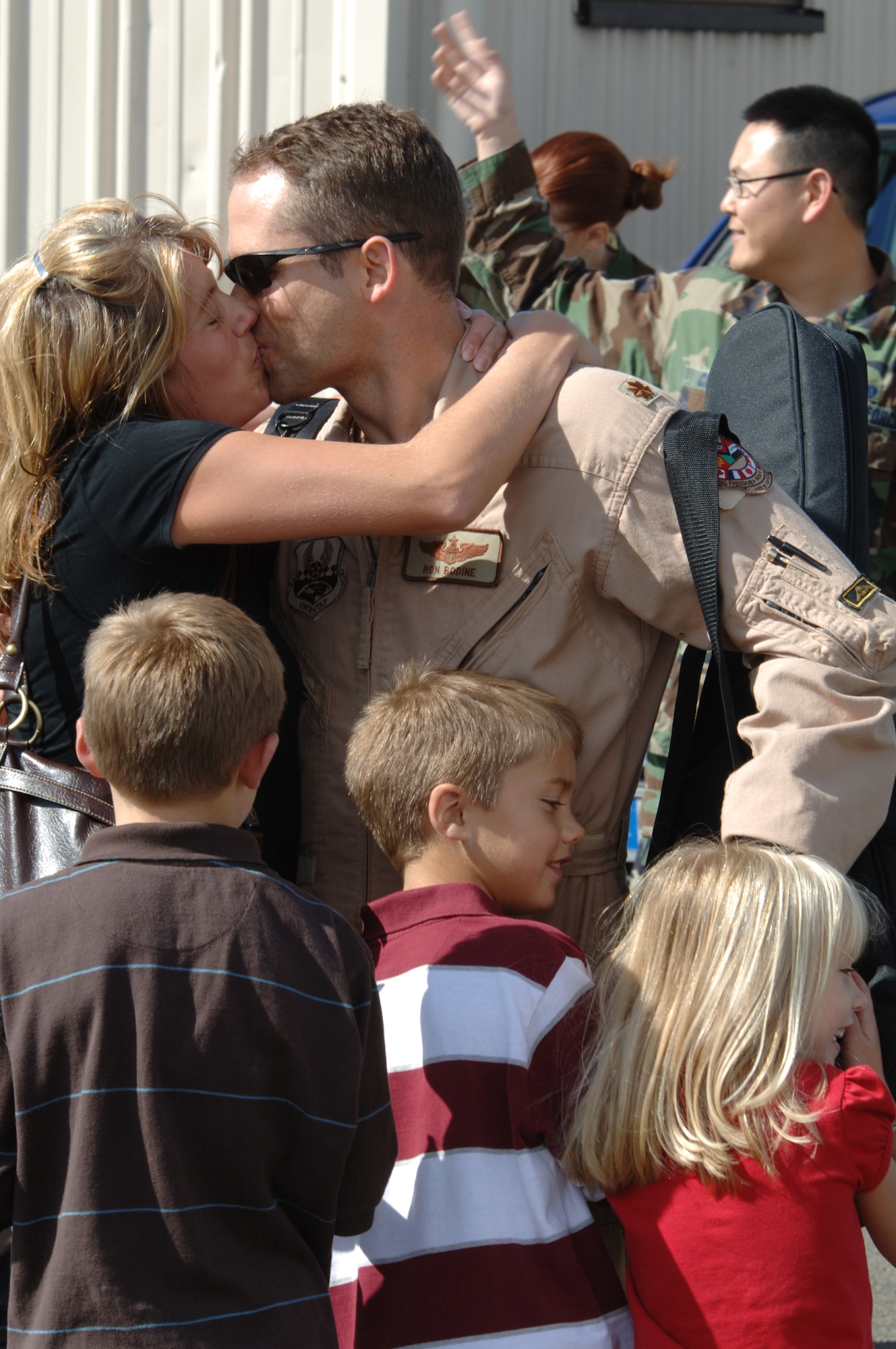 Maj. Ron Bodine, 603rd Air Operations Center, is greeted by his family during his redeployment in September. The Air Force recently clarified post-deployment stand-down time. (Photo by Airman 1st Class Marc I. Lane)
