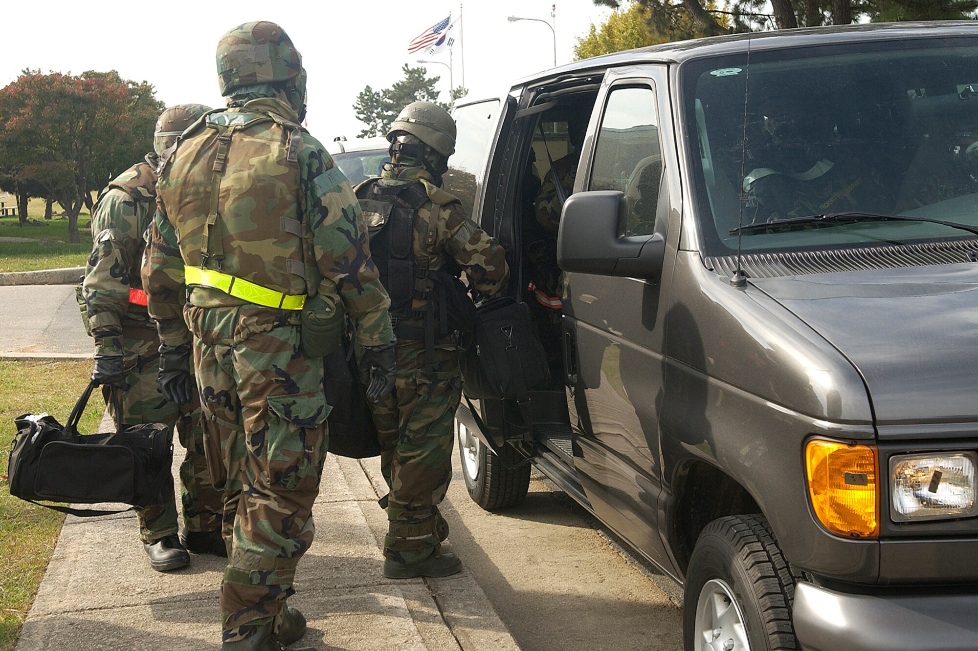 KUNSAN AIR BASE, South Korea-- Members of the 8th Fighter Wing enter a vehicle to relocate during the Peninsula Operational Readiness Exercise here Nov. 6. The exercise is conducted to ensure members of the Wolf Pack remain ready to execute its mission of “Defending the Base, Accepting Follow on Forces and Taking the Fight North.” (U.S. Air Force photo/Senior Airman Giang Nguyen)                               