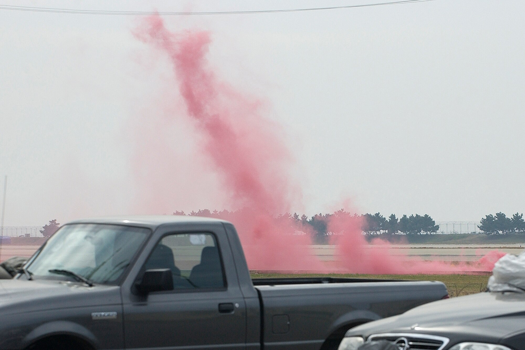 KUNSAN AIR BASE, South Korea--Smoke rises from the flight line to simulate a ground attack in front of the 8th Fighter Wing Headquarters building during the Peninsula Operational Readiness Exercise here Nov 6. The exercise is conducted to ensure members of the Wolf Pack remain ready to execute its mission of “Defending the Base, Accepting Follow on Forces and Taking the Fight North.”  (U.S. Air Force photo/Senior Airman Giang Nguyen)                               