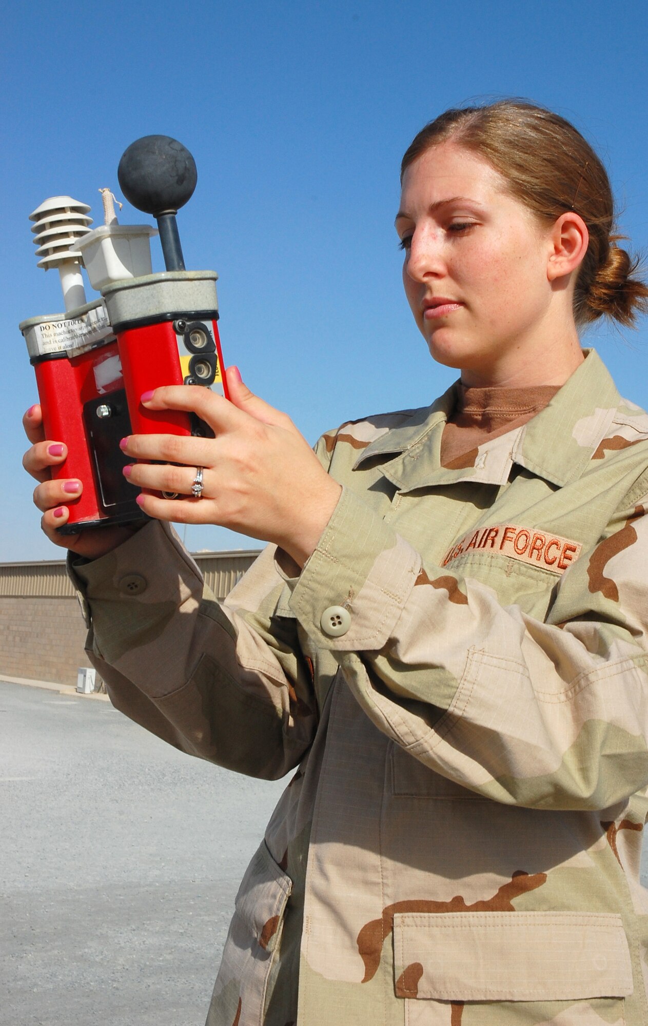 SOUTHWEST ASIA -- Staff Sgt. Tricia Williamson, 386th Expeditionary Operations Group weather forecaster, conducts a wet bulb globe temperature test, which calculates the heat stress level for the base, Nov. 2 here.  Sergeant Williamson is deployed from Royal Air Force Mildenhall, England.  (U.S. Air Force photo by Staff Sgt. Tia Schroeder)
